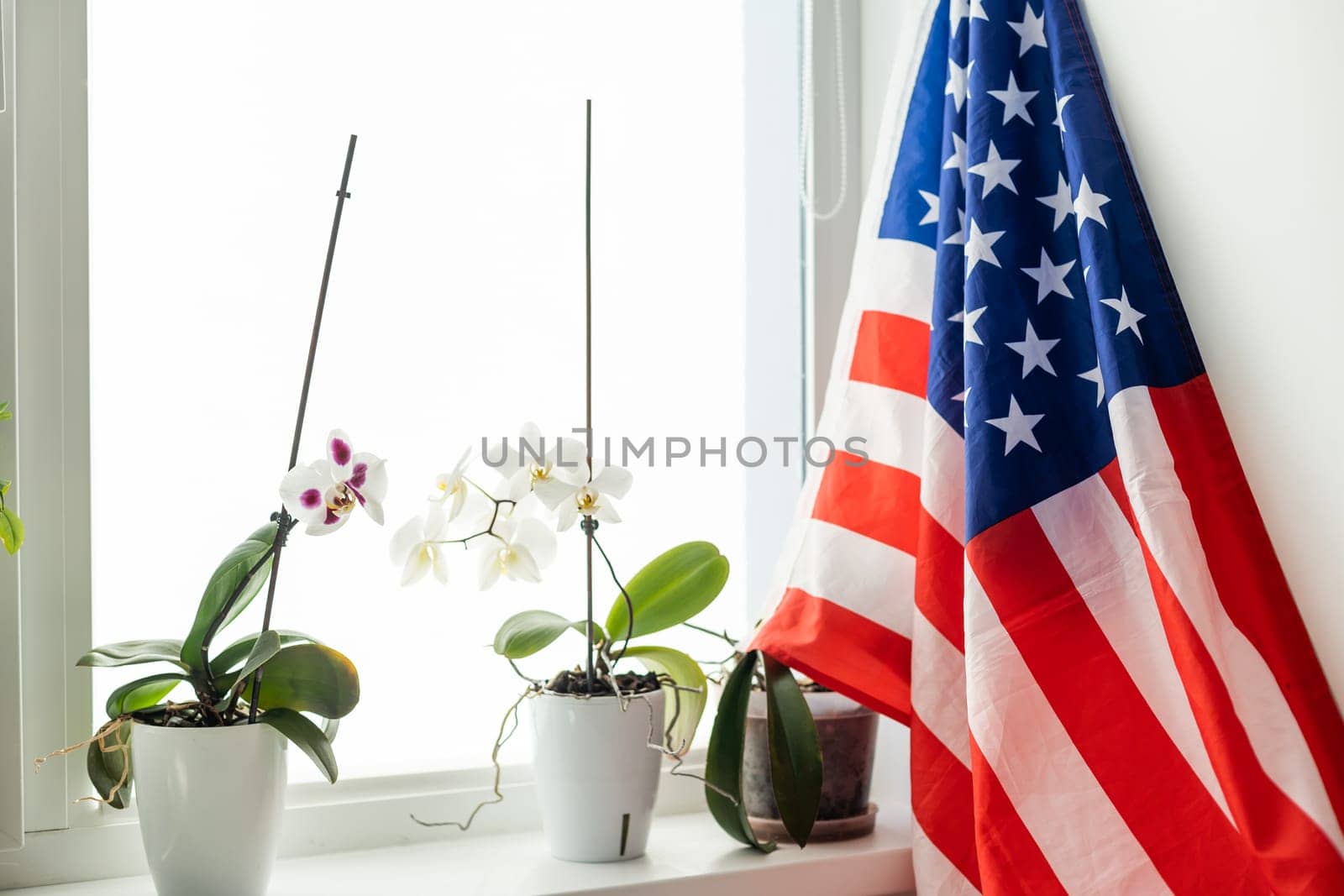 Interior of stylish room with modern workplace and USA flag. High quality photo