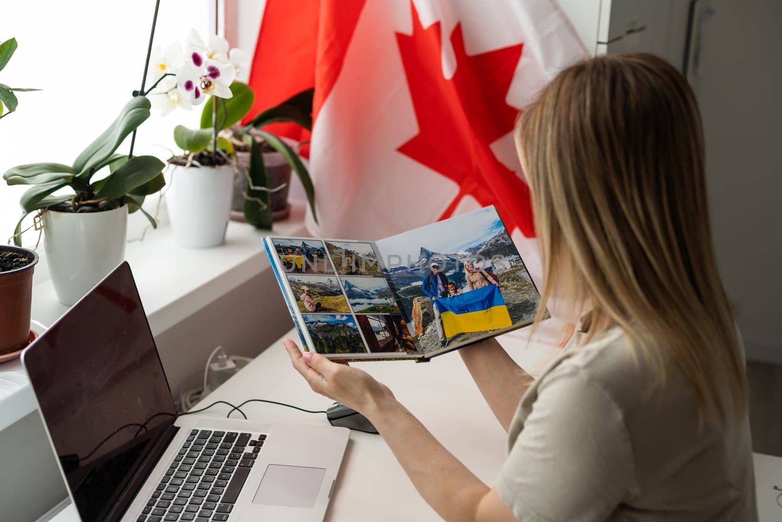 Young female student with Canadian flag and laptop with space for text by Andelov13