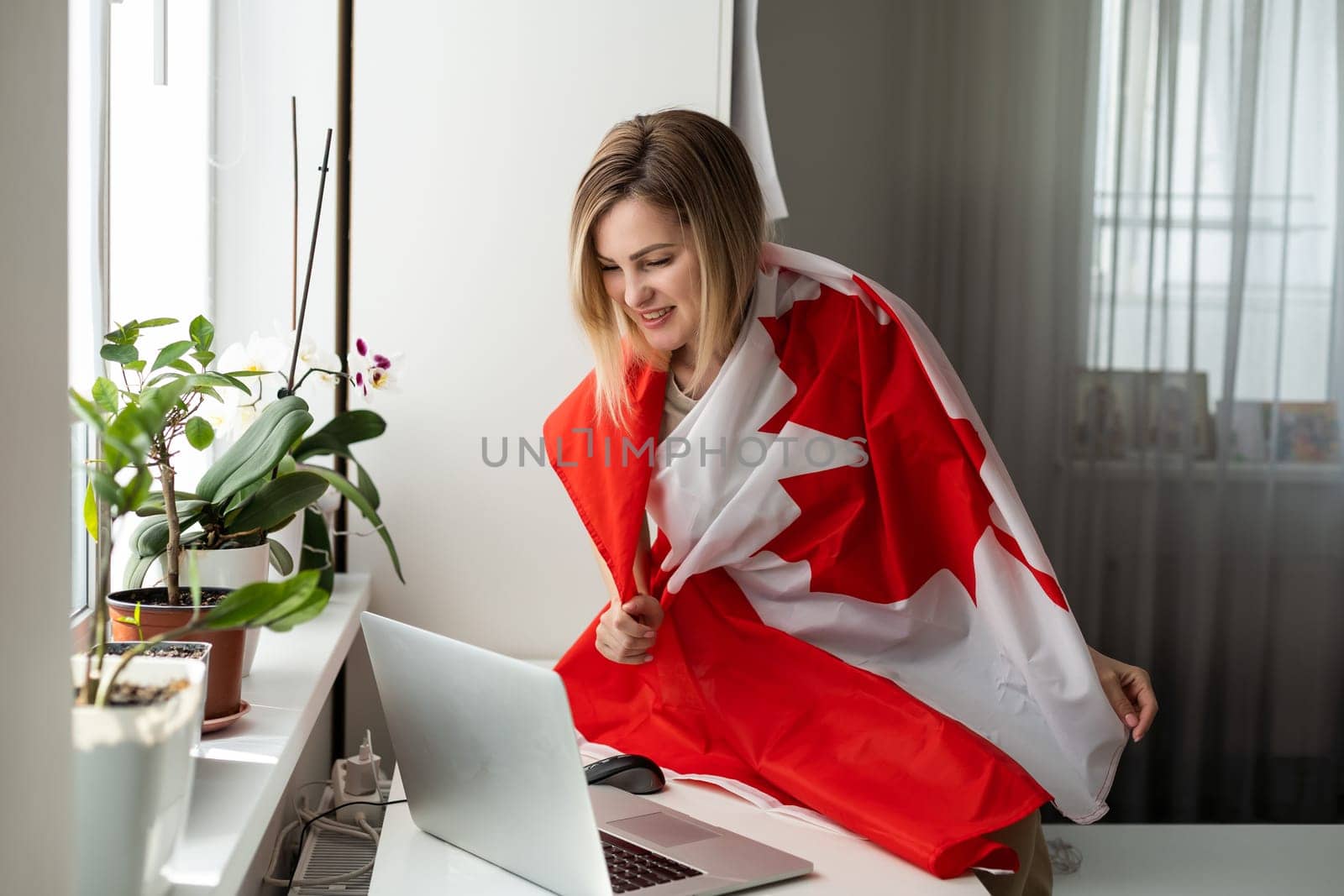 woman hands and flag of Canada on computer, laptop keyboard by Andelov13