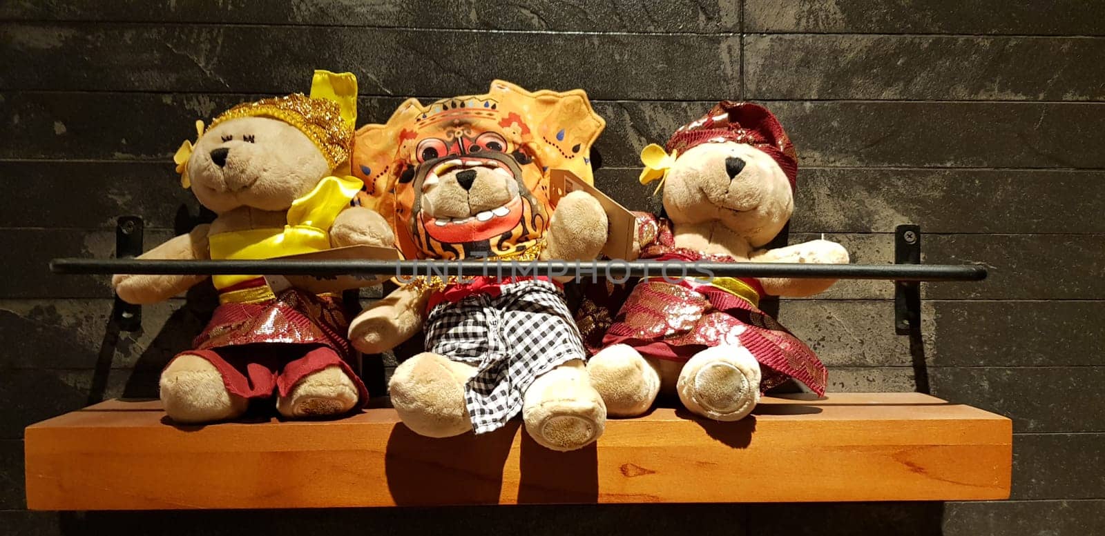 Group of Fluffy Stuffed Bear Toys Wearing various Clothes, teddy bear stuffed animal sitting in the wood bracket