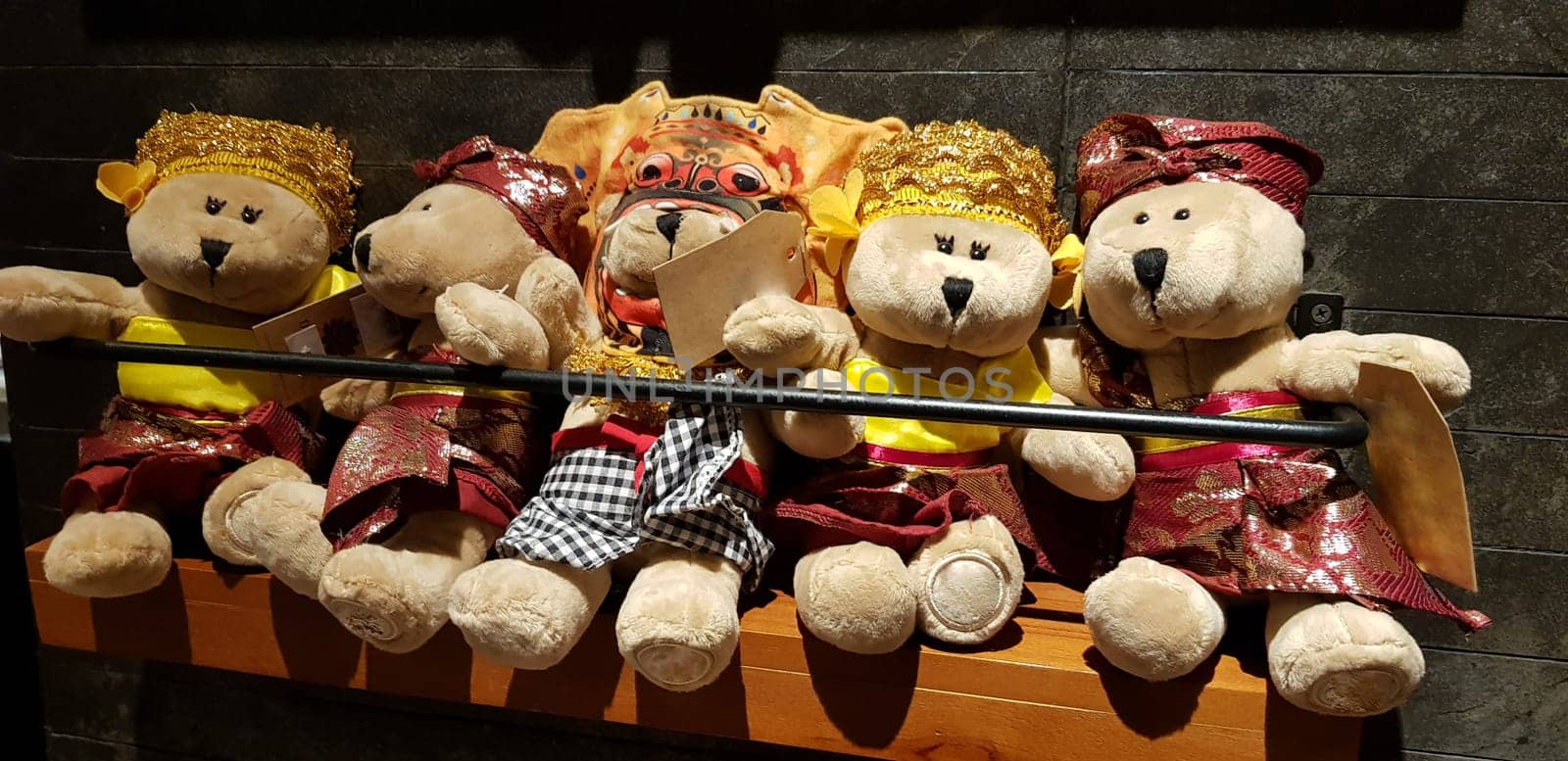 Group of Fluffy Stuffed Bear Toys Wearing various Clothes, teddy bear stuffed animal sitting in the wood bracket