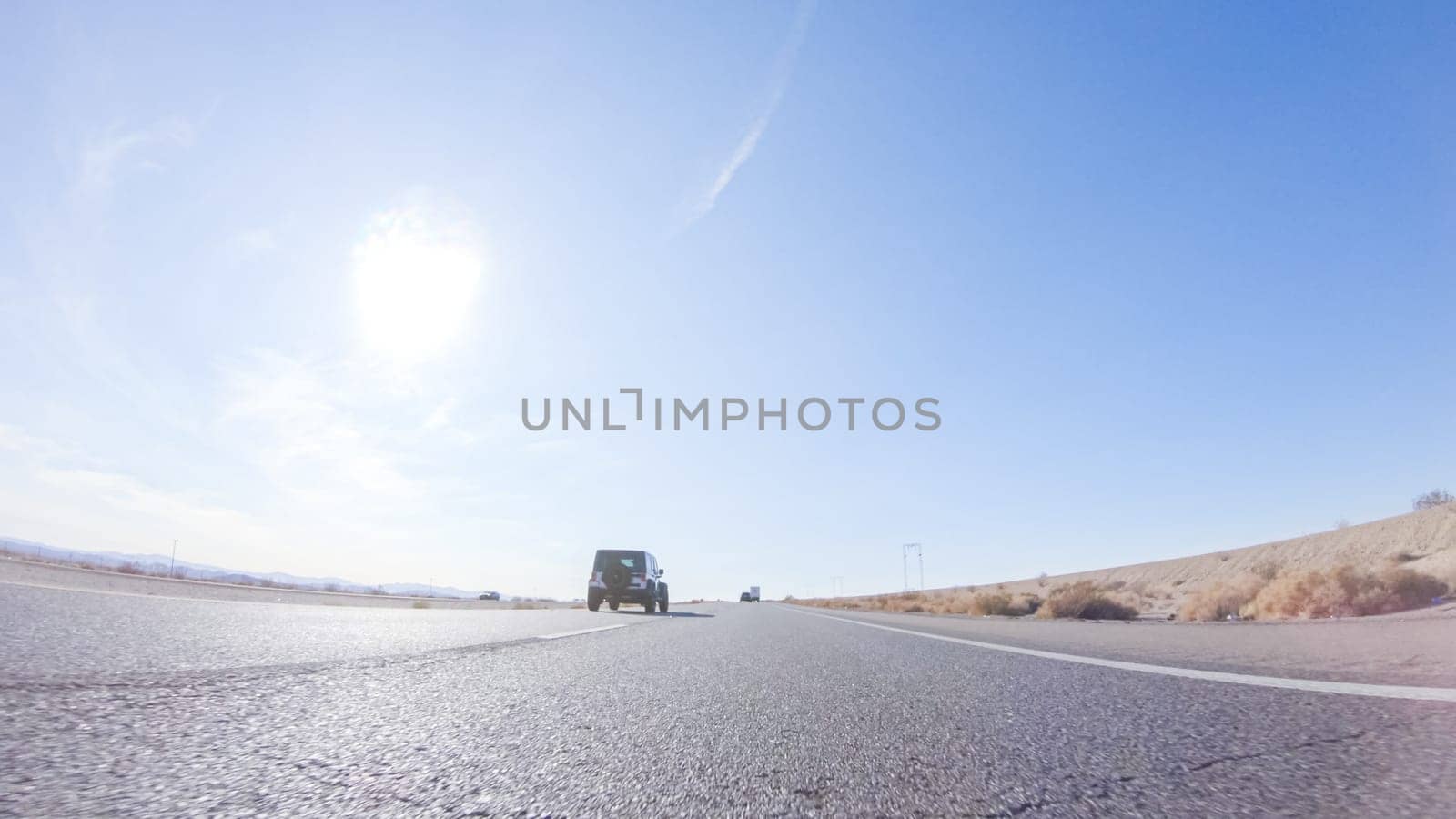 Embarking on a road trip from Nevada to California, driving on Highway 15 during the day offers scenic views and an exciting journey between states.