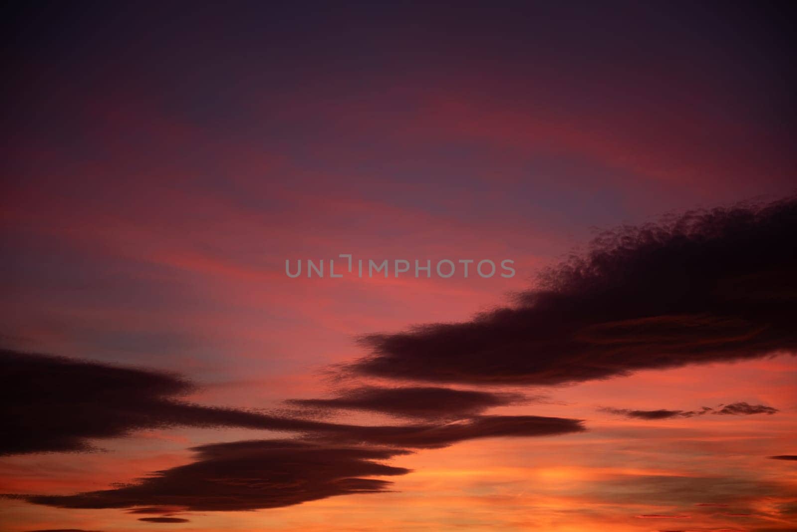 Fiery Sunset Sky Illuminated by Colorful Clouds by raul_ruiz