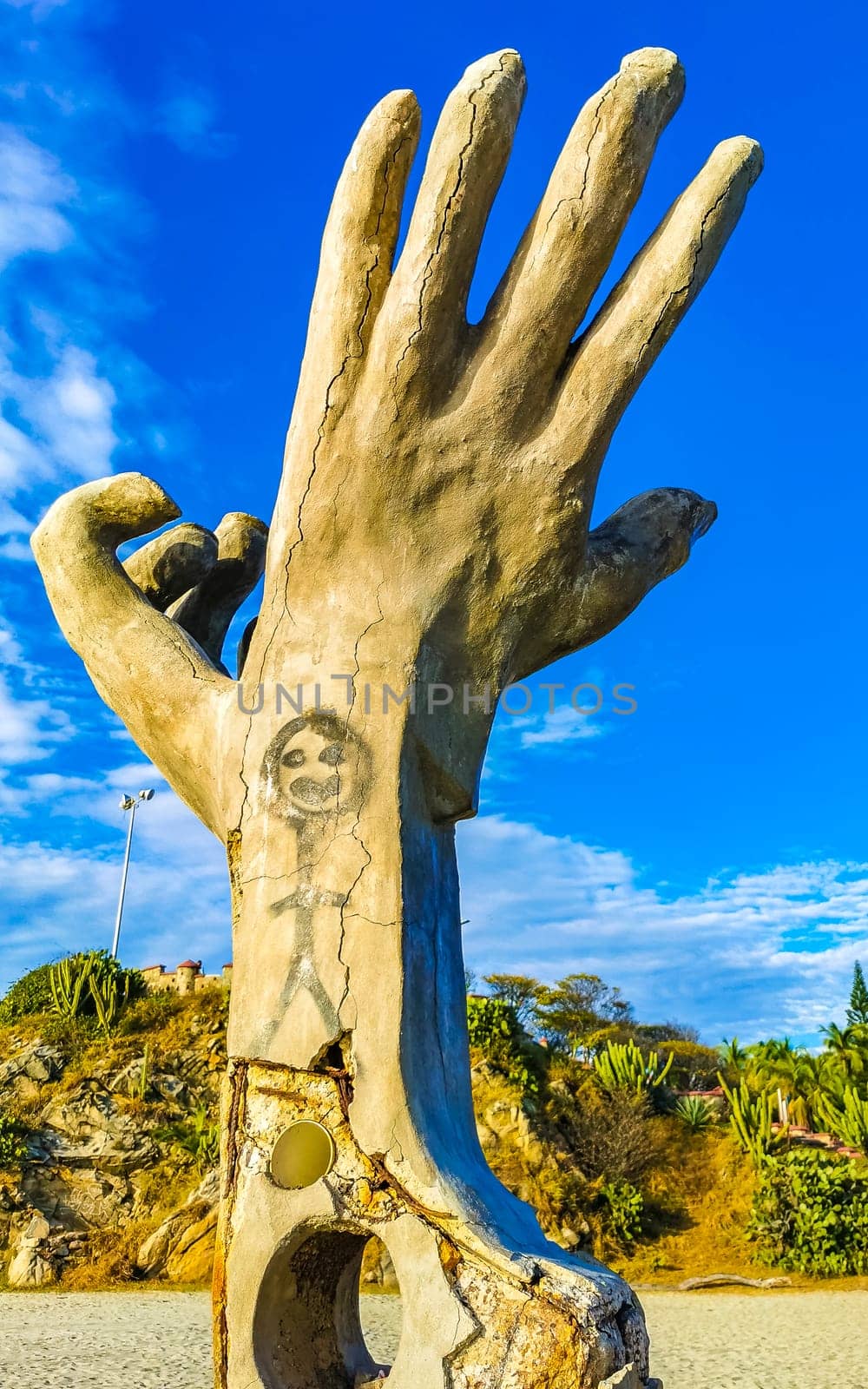 Hands stone rock statue sculpture beach Puerto Escondido Mexico. by Arkadij