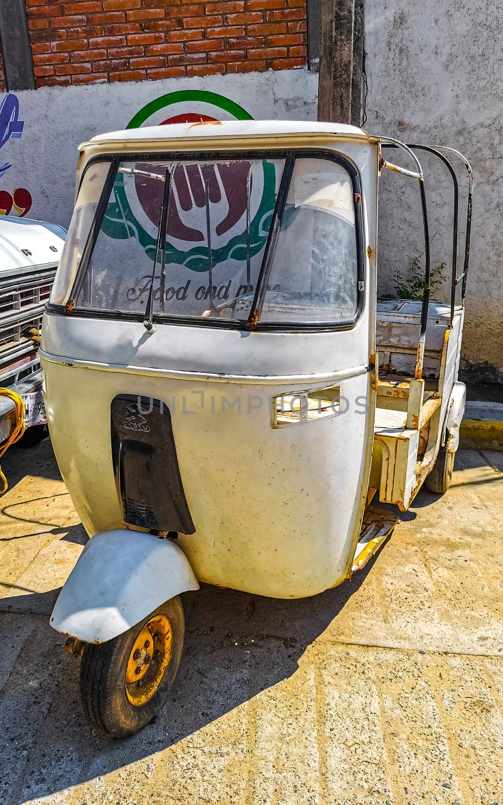 Puerto Escondido Oaxaca Mexico 20. January 2023 White tuk tuk tricycle TukTuks rickshaw in Zicatela Puerto Escondido Oaxaca Mexico.