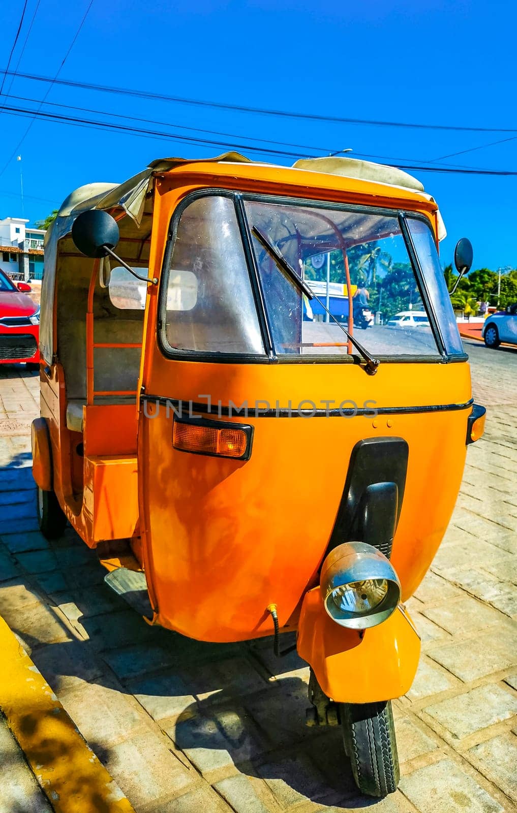 Puerto Escondido Oaxaca Mexico 31. January 2023 Orange tuk tuk tricycle TukTuks rickshaw in Zicatela Puerto Escondido Oaxaca Mexico.