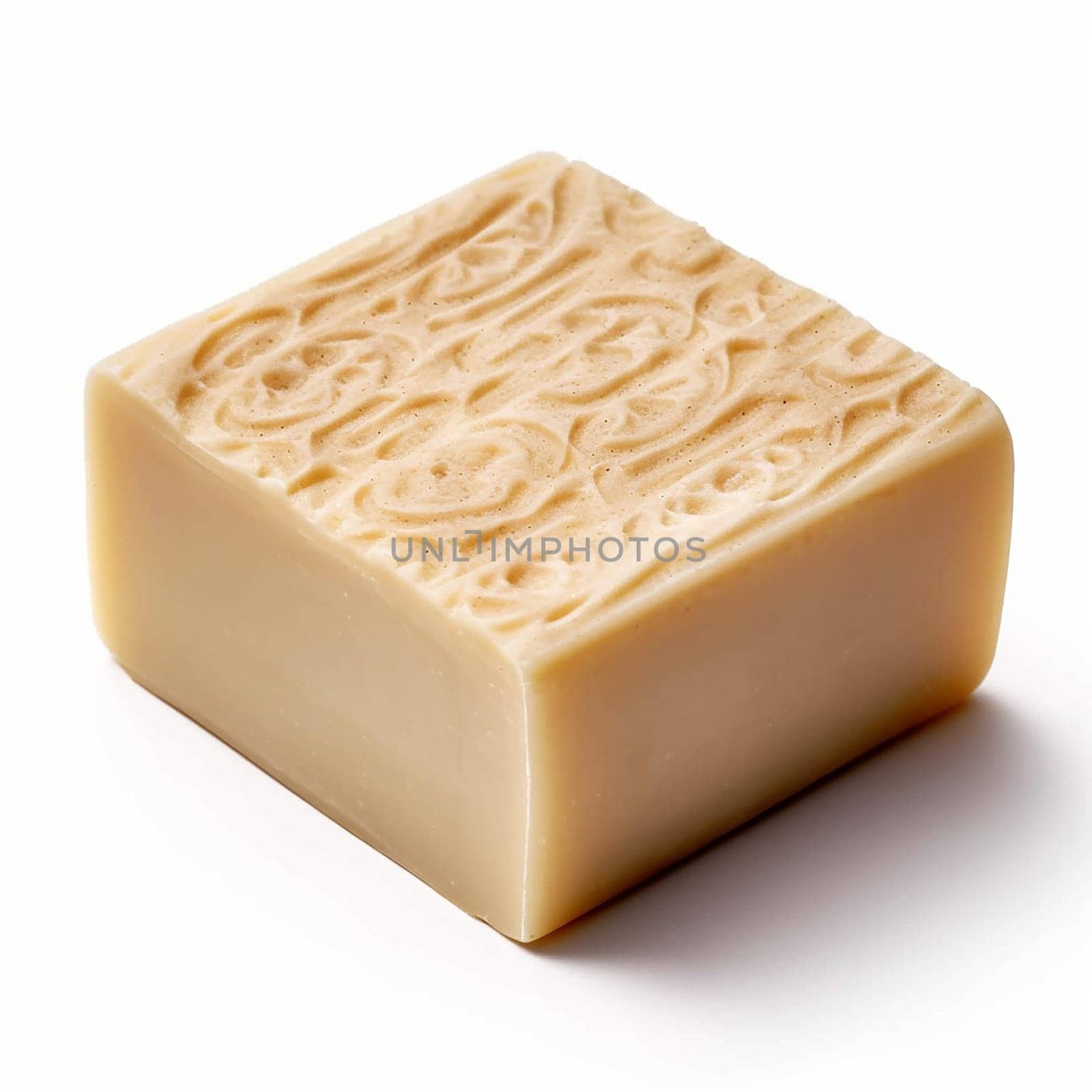 A single bar of beige handmade soap with embossed patterns on top.