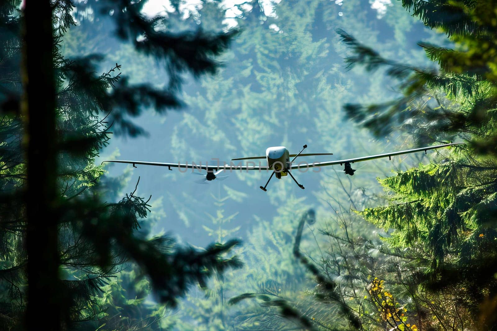 Military airplane flies over a dense forest filled with trees