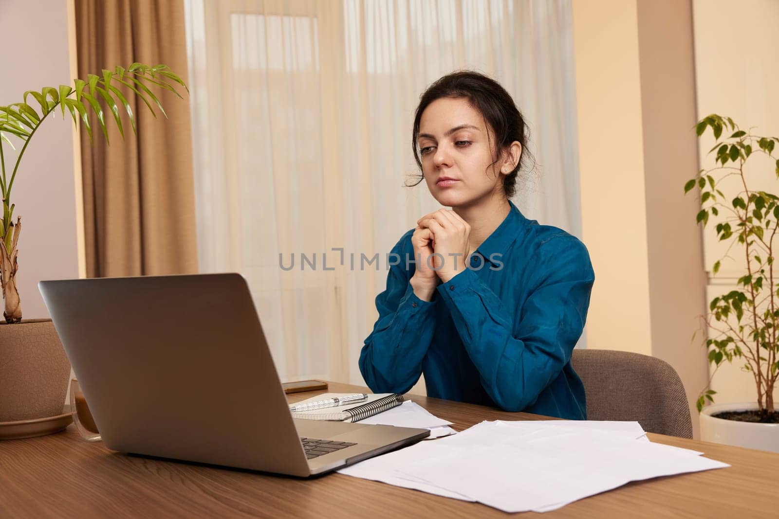 pretty calm woman using laptop at home by erstudio