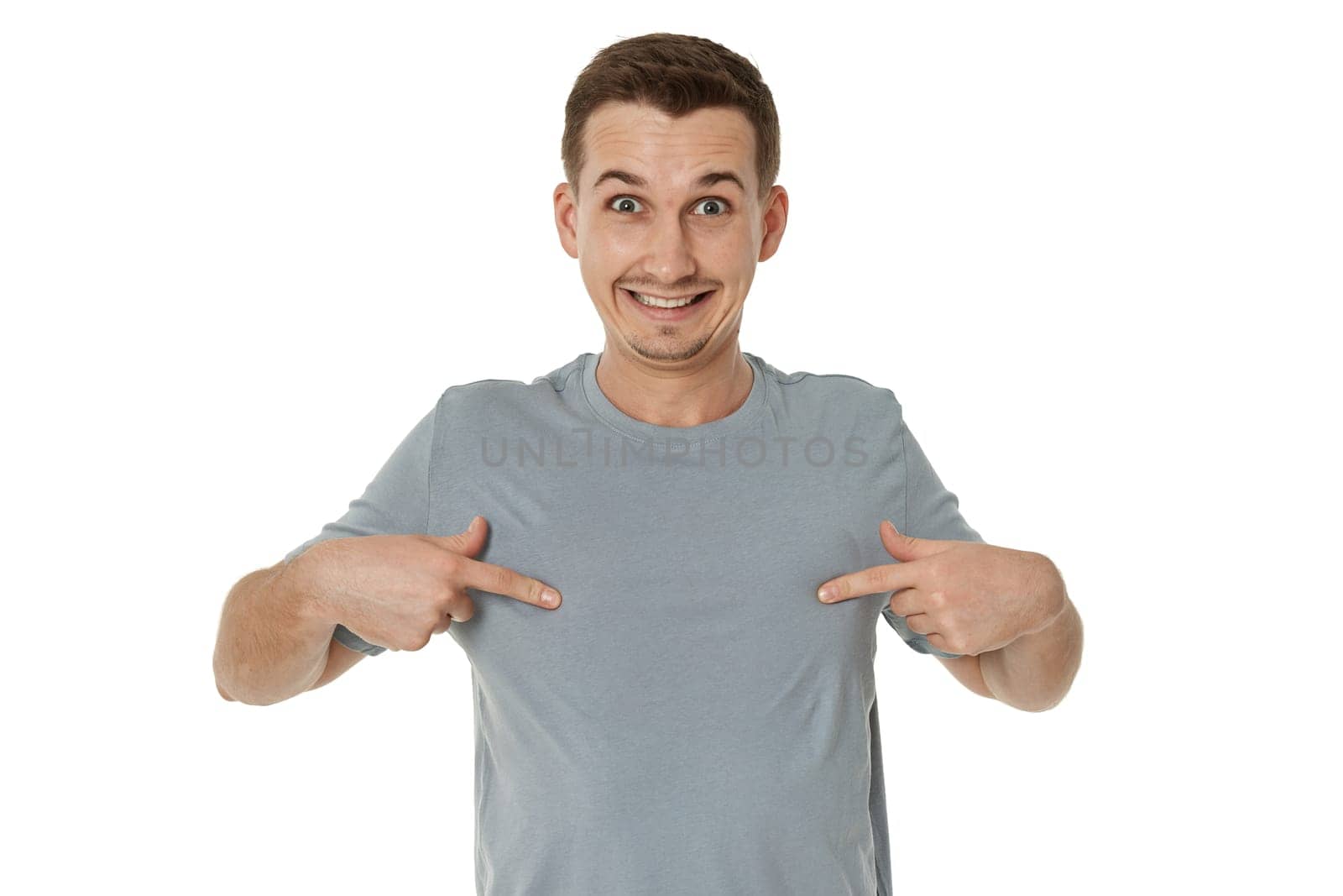 happy guy looking pointing at himself on white studio background