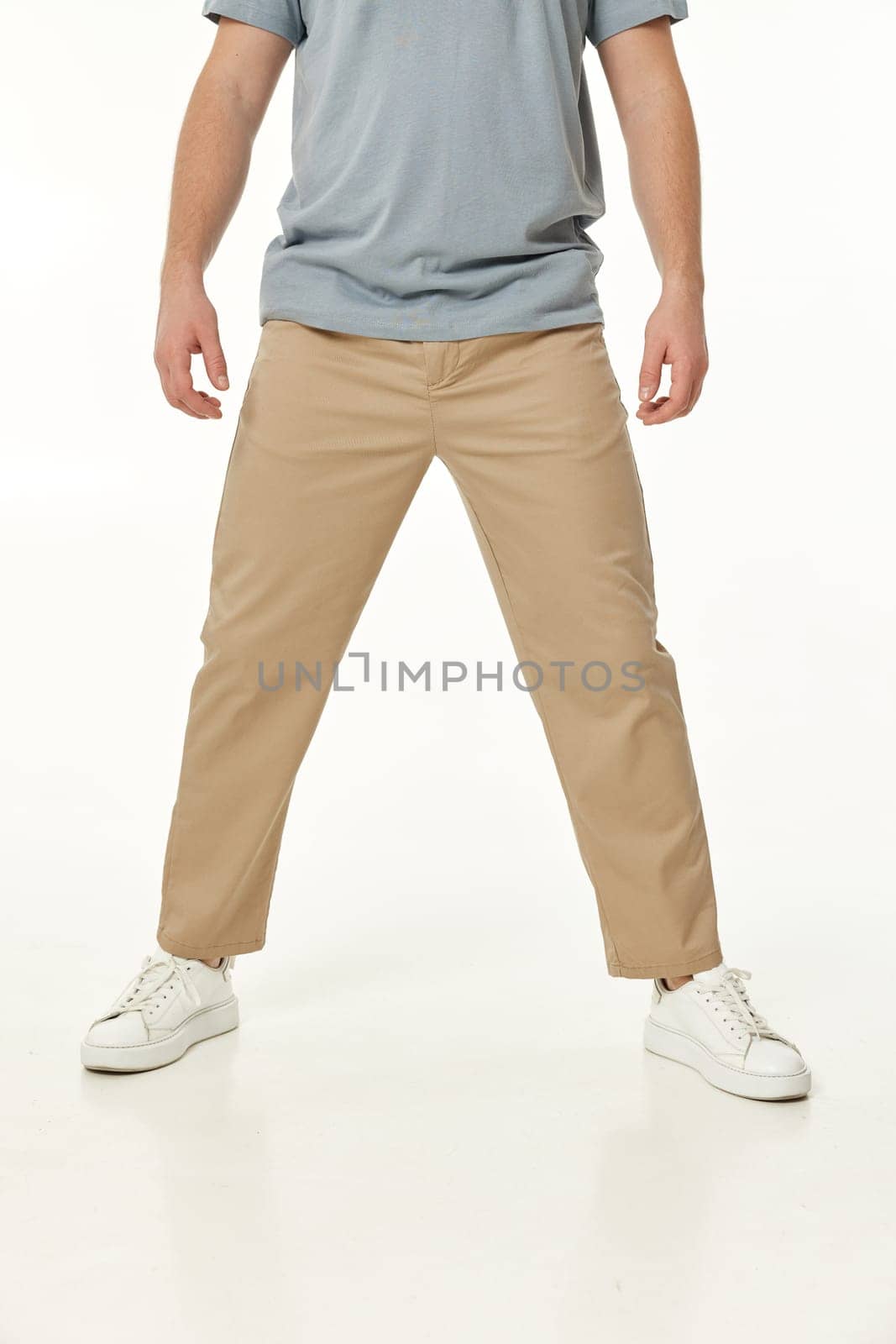 man wearing white sneakers and casual beige pants by erstudio