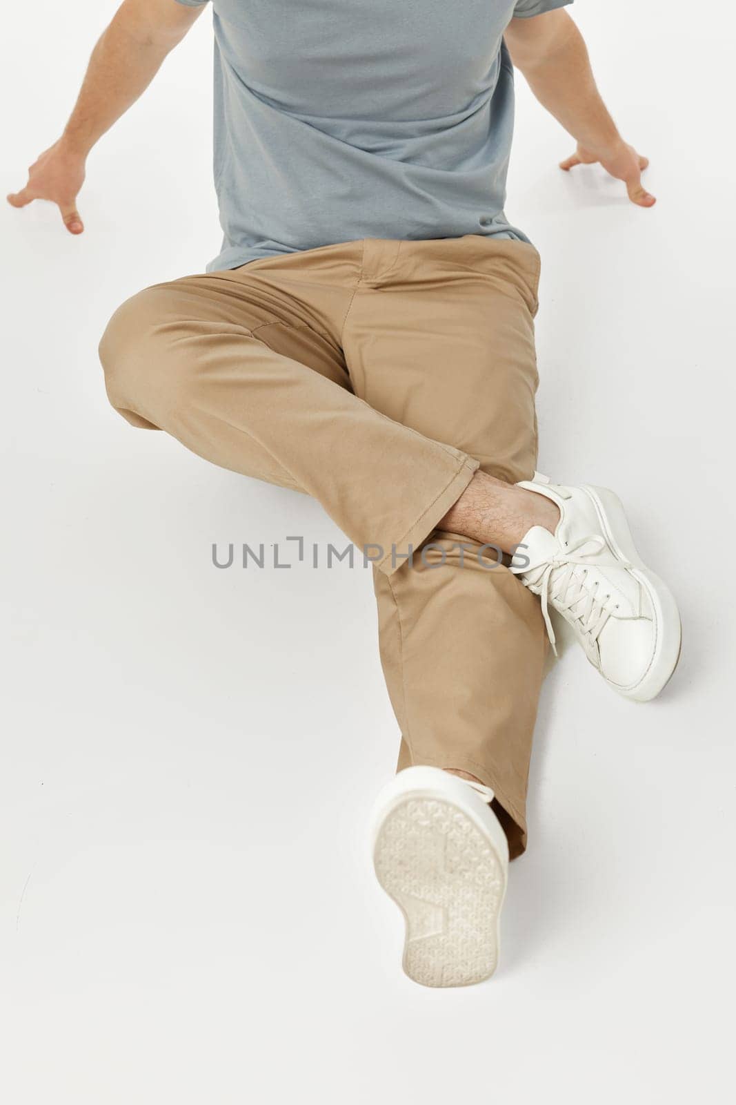 man wearing white sneakers and casual beige pants by erstudio