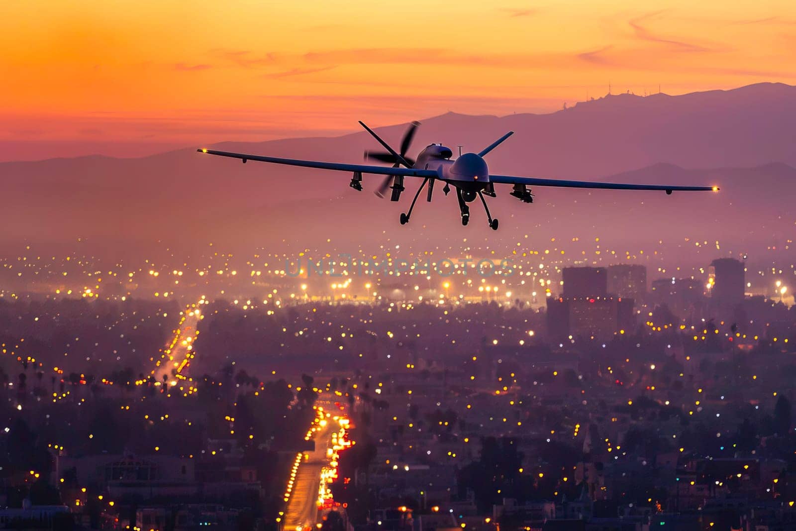 Military unmanned airplane flies over a city at night, illuminating the urban landscape below with its lights.