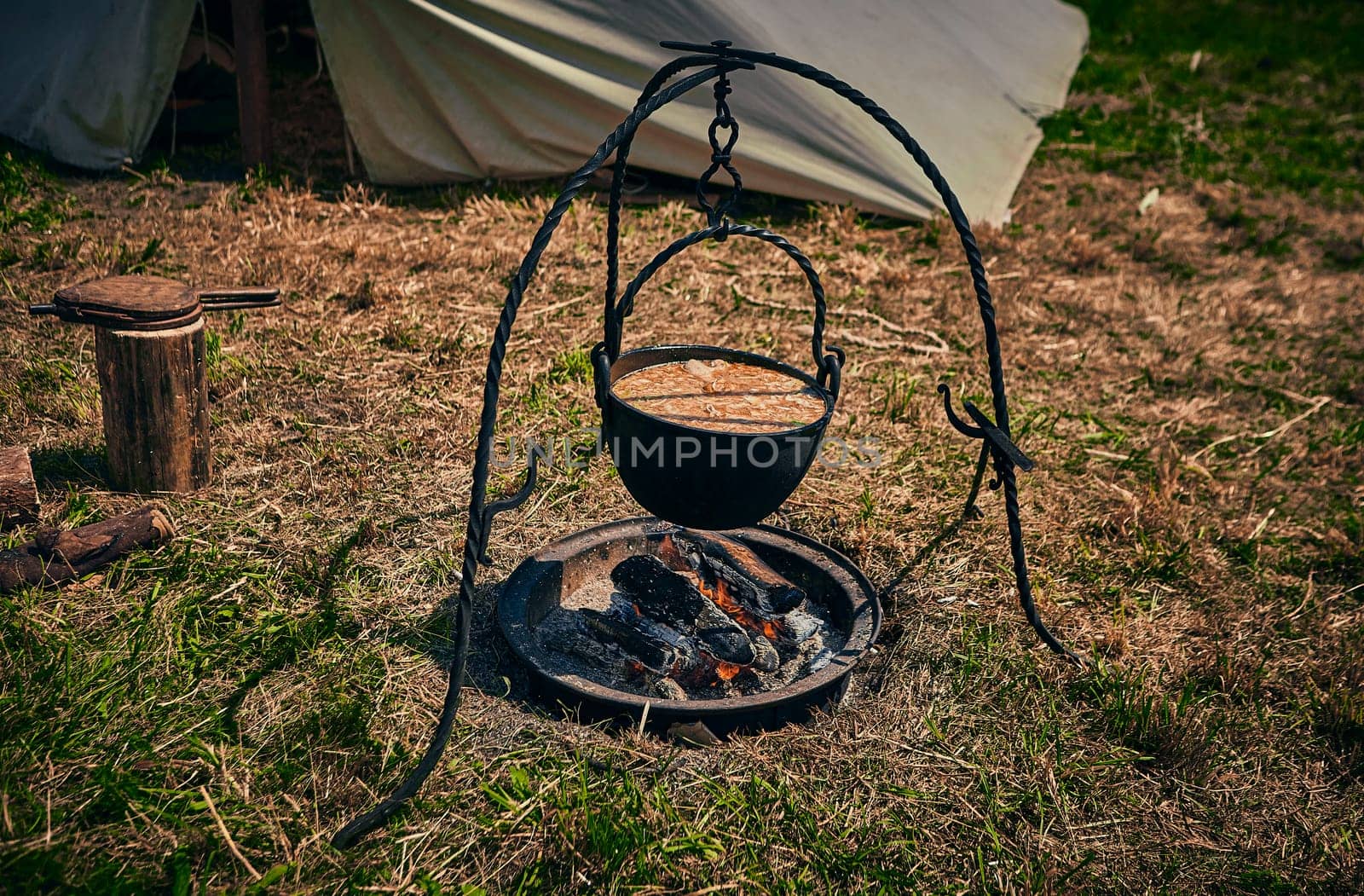 Camping. Soup in a pot over a fire. Stylization under the Middle Ages, vintage by Hil
