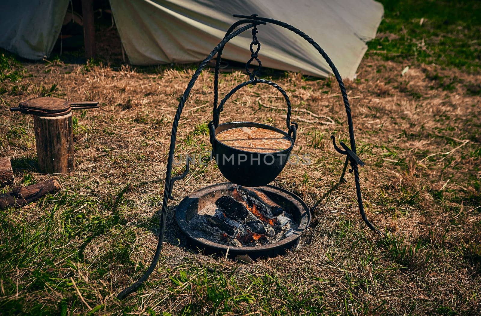 Camping. Soup in a pot over a fire. Stylization under the Middle Ages, vintage.