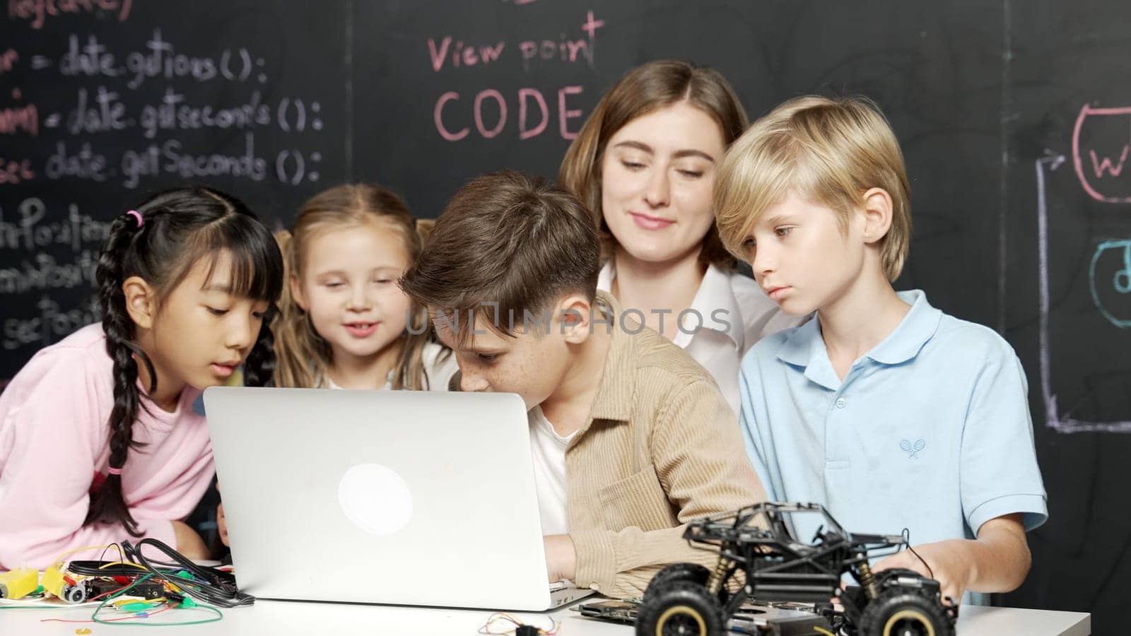 Boy using laptop programing engineering code and writing program. Erudition. by biancoblue