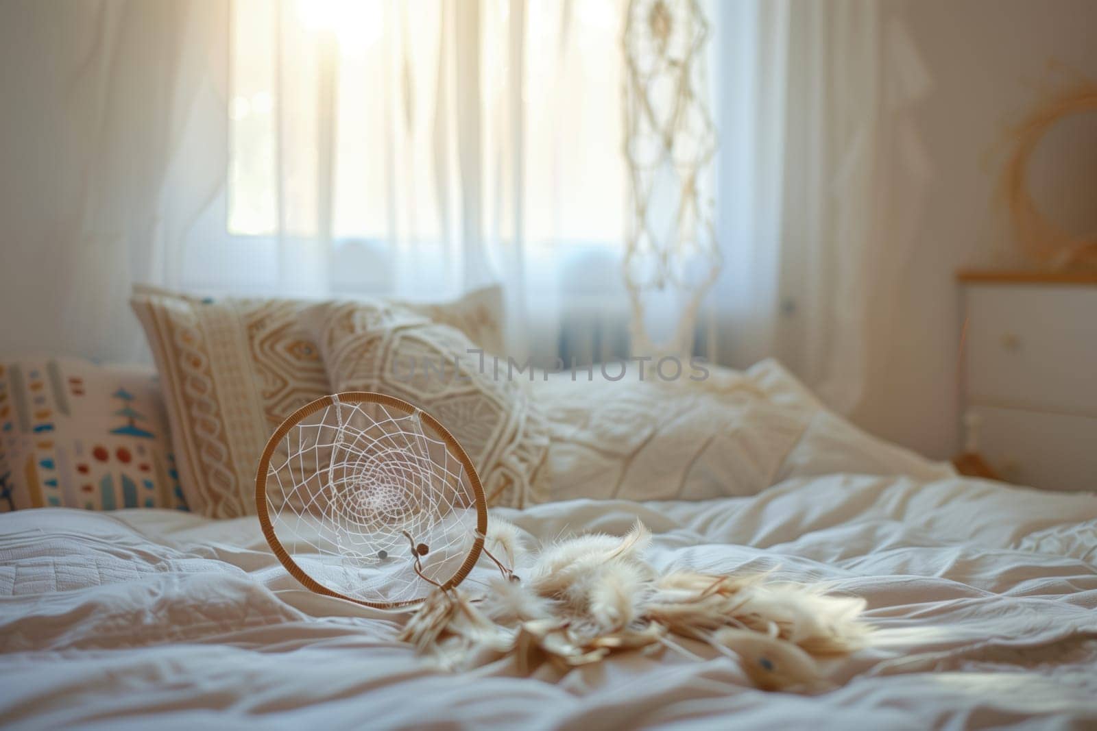 A dream catcher adorns the bed frame in the cozy, wellfurnished bedroom by richwolf