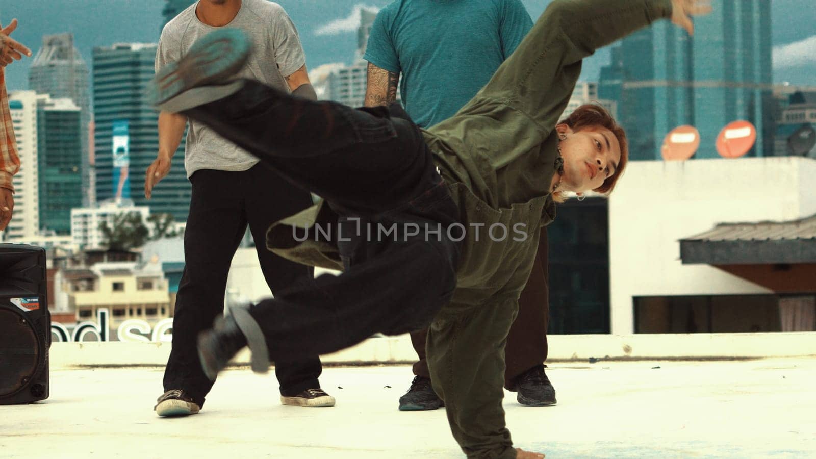 Professional asian break dancer practice B boy dance while multicultural friends at rooftop. Young modern dancing group doing hip hop movement. Style,fashion,action. Outdoor sport 2024. Endeavor.