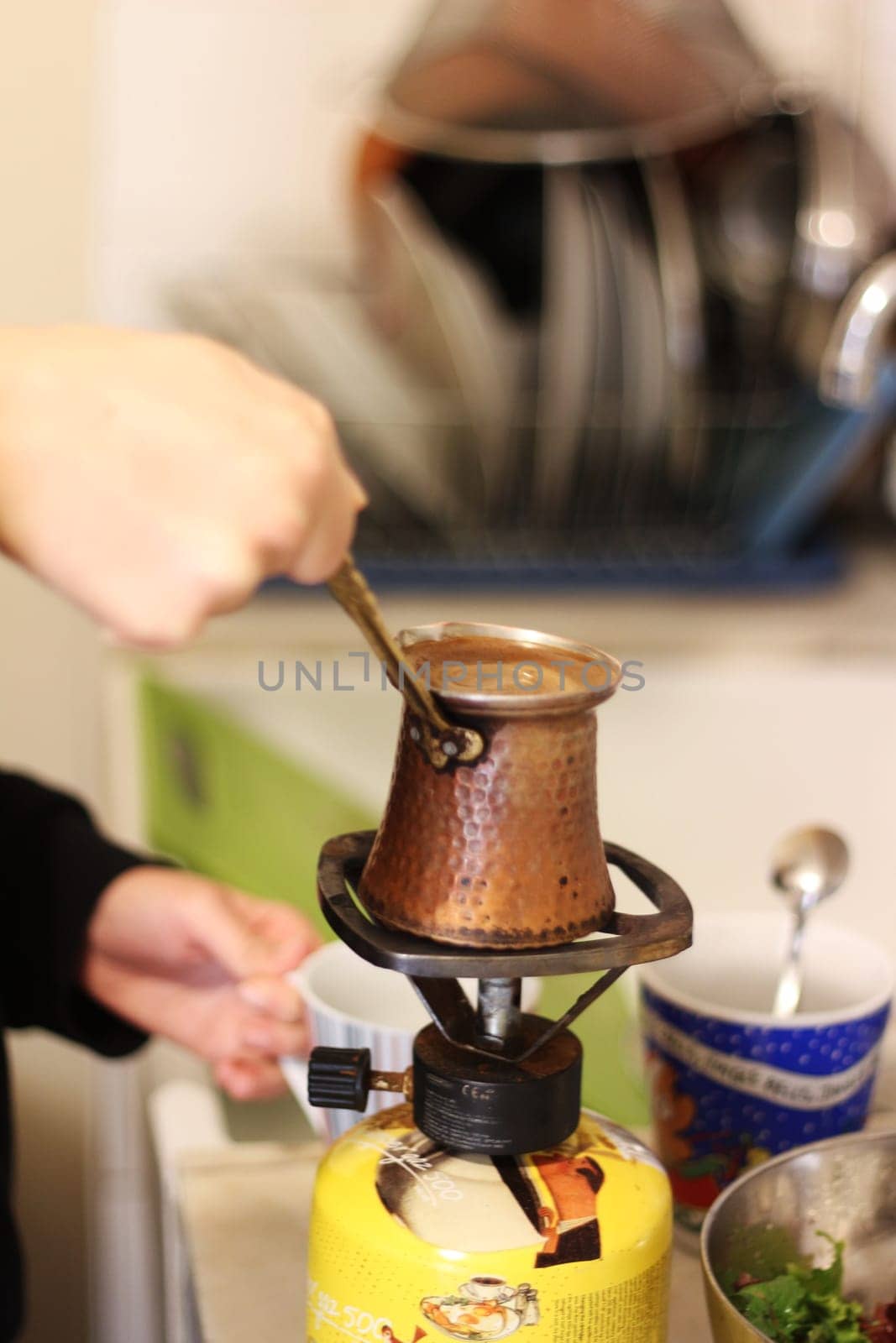 Step into a world of warmth and tradition as Greek coffee brews gently on a small gas burner, reminiscent of the beloved Turkish coffee ritual.