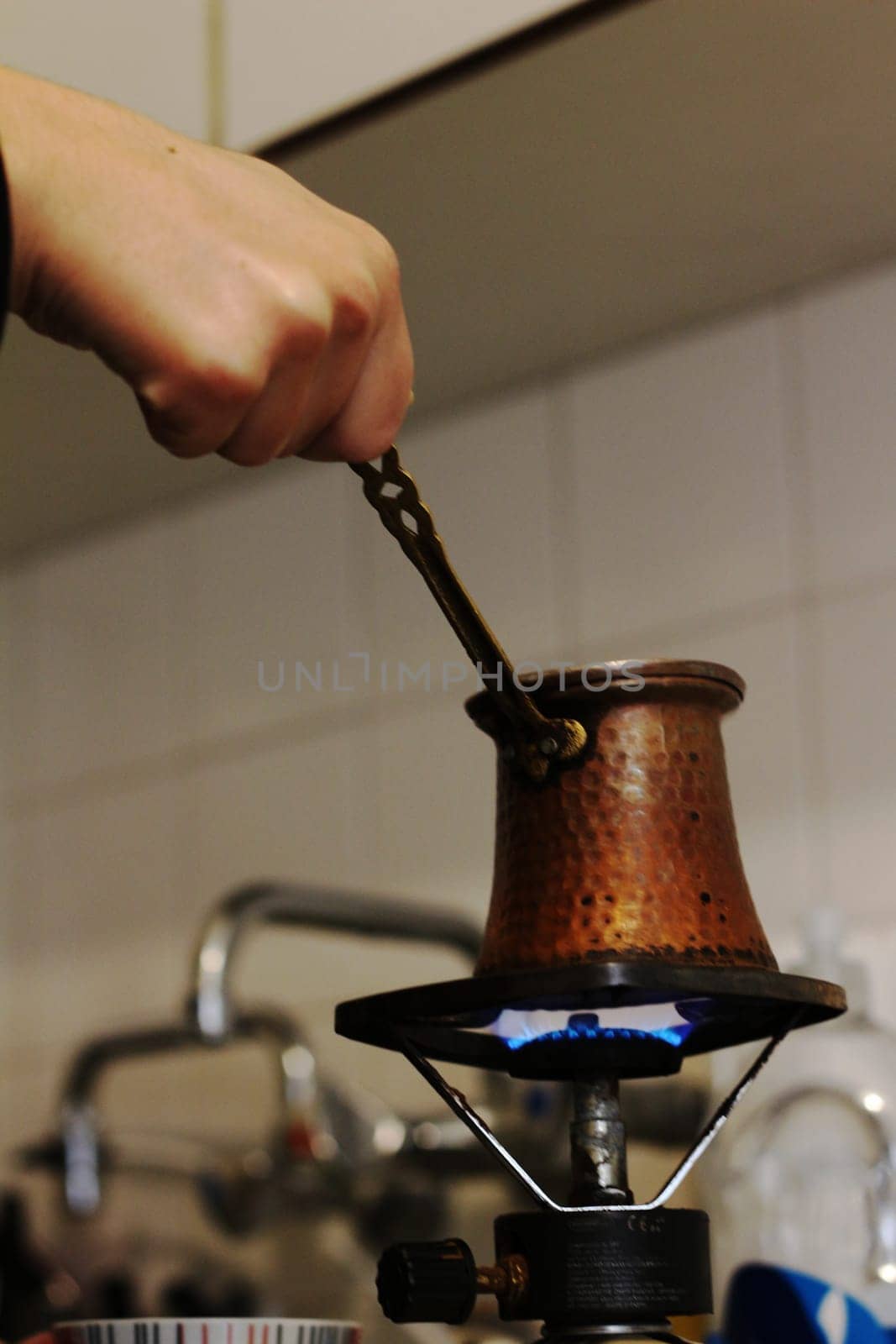 Step into a world of warmth and tradition as Greek coffee brews gently on a small gas burner, reminiscent of the beloved Turkish coffee ritual.