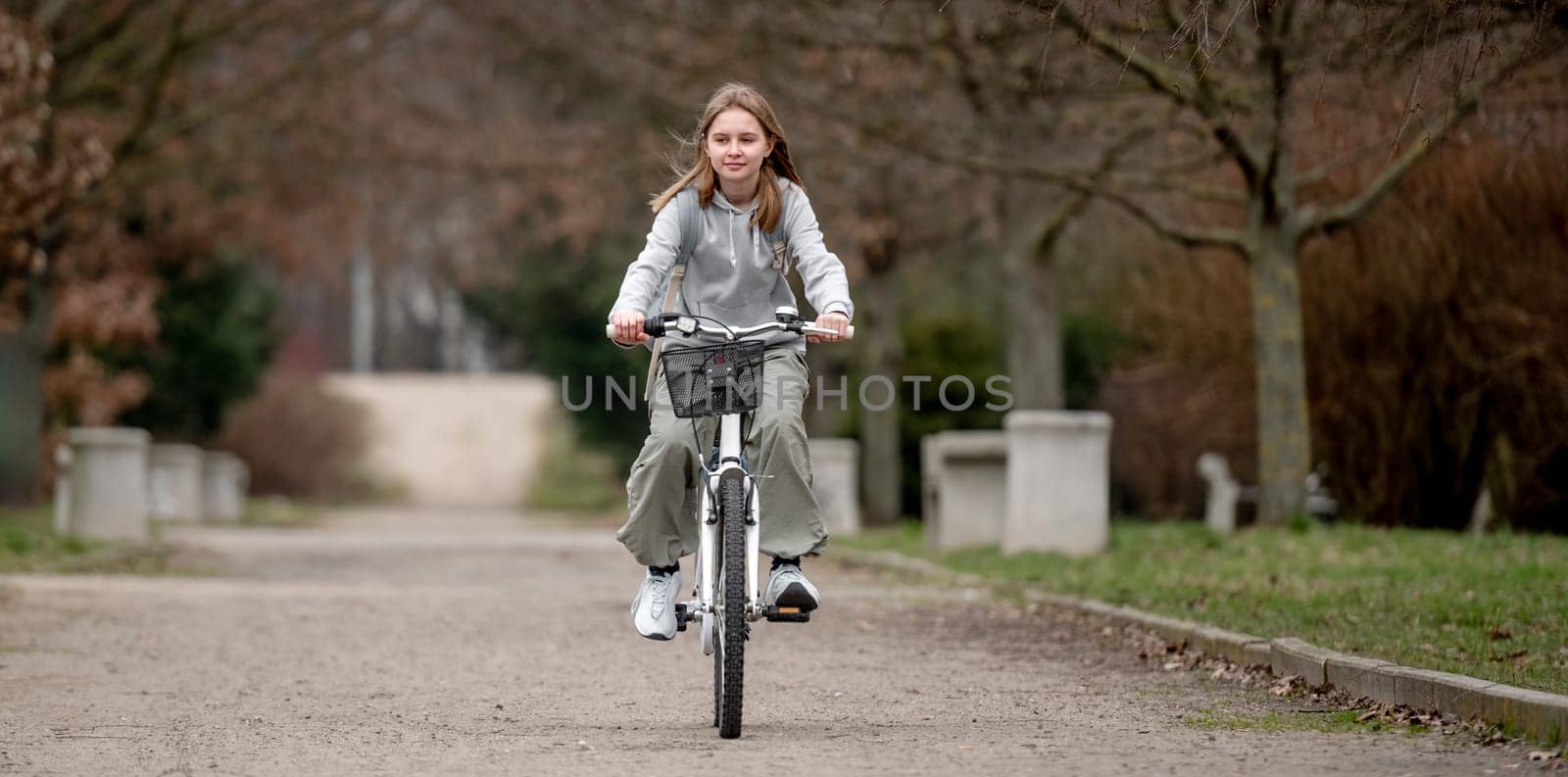Warm Weather Sees Girl Riding Bicycle Through Spring Park