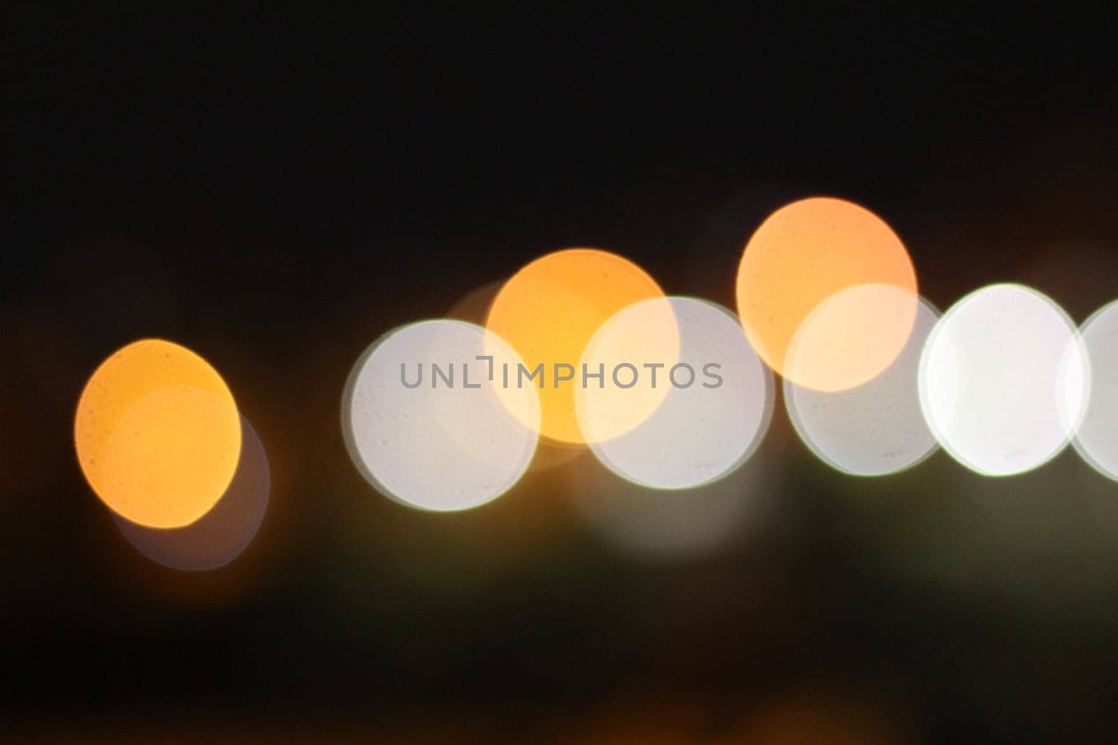 Immerse yourself in the mesmerizing allure of the urban night as abstract bokeh lights illuminate the darkness with a dazzling display of colors and shapes