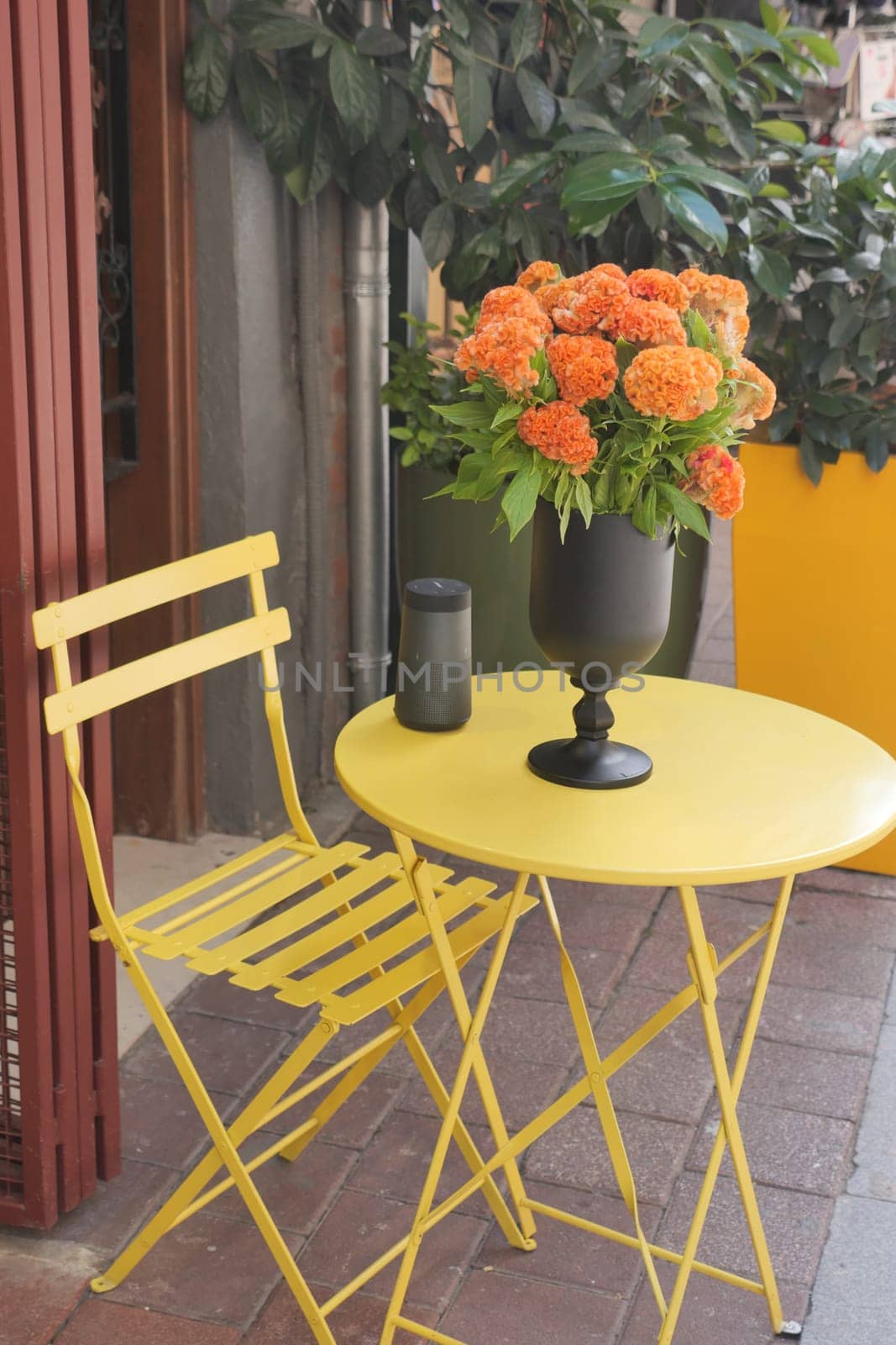 A yellow table adorned with a vase of flowers as decoration,