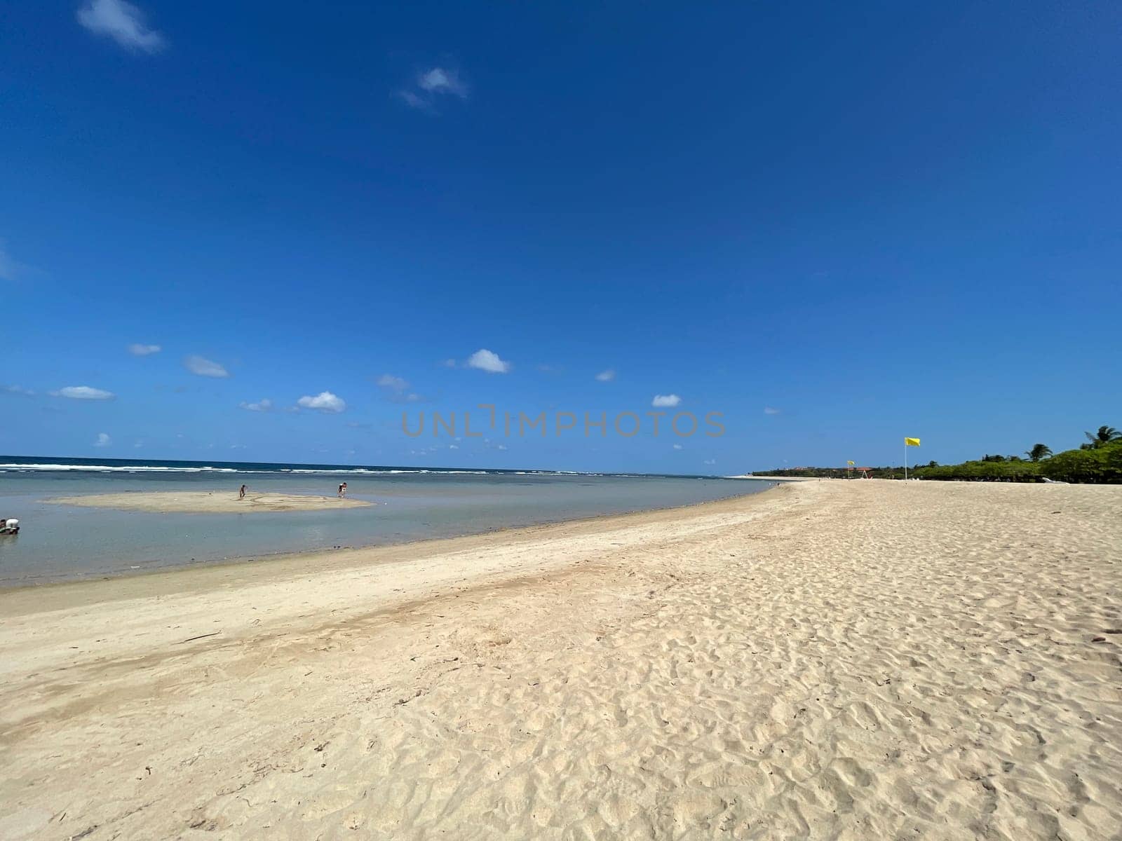 Tropical beach in sunny weather with blue sky and white sands Panorama of a beautiful white sand beach and turquoise water, Holiday summer beach background Wave of the sea on the sand beach