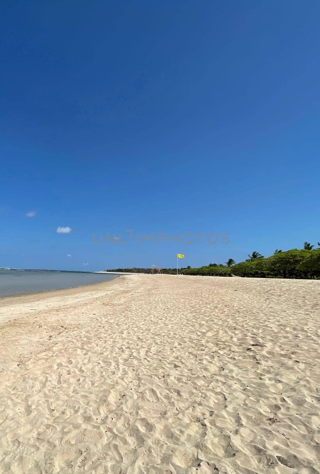 Tropical beach in sunny weather with blue sky and white sands Panorama of a beautiful white sand beach and turquoise water, Holiday summer beach background Wave of the sea on the sand beach