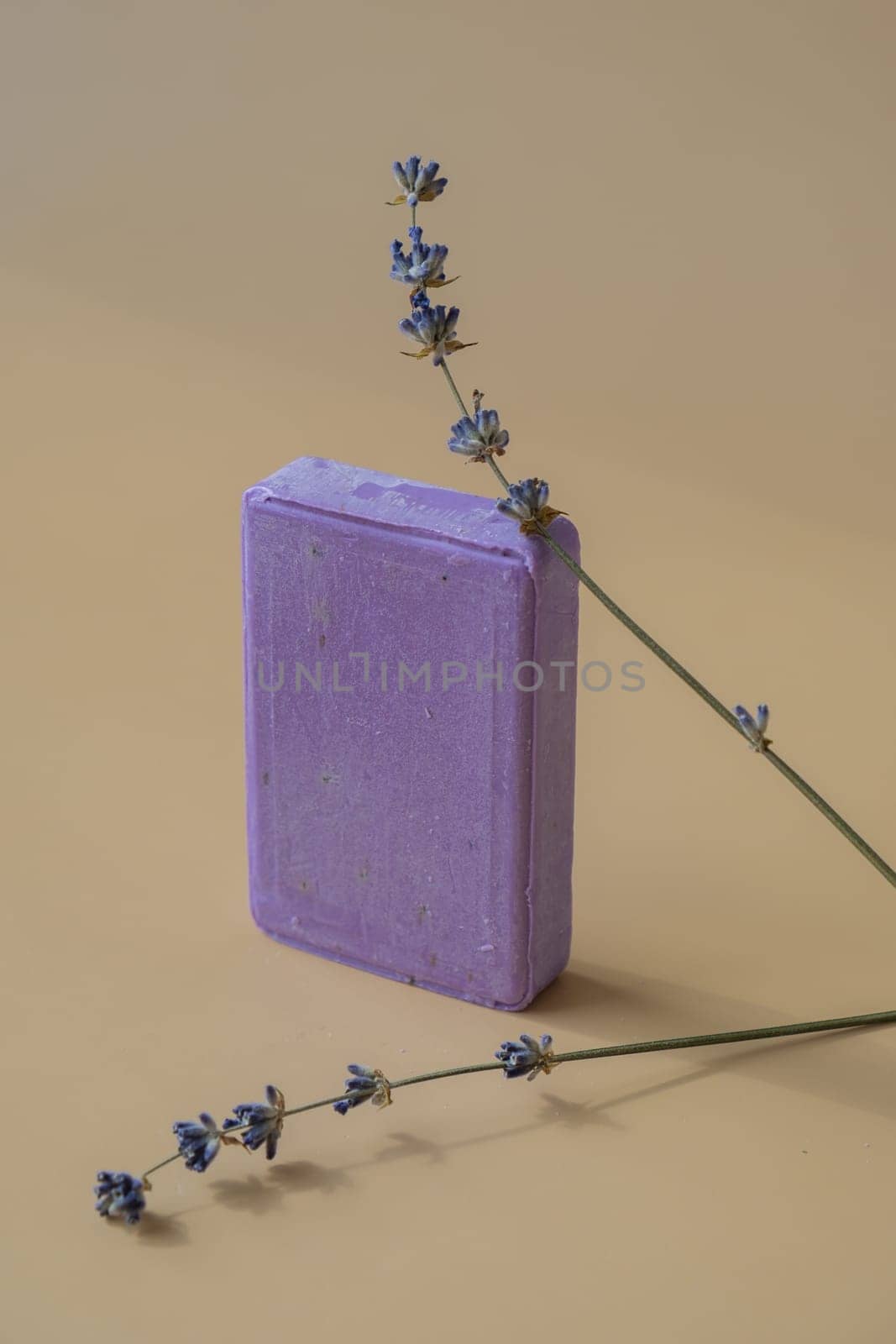 Lavender soap on beige background with copy space for your text. Advertisement template mock up. Skincare homemade natural cosmetic concept. Organic dry lavender flower. Handmade soap