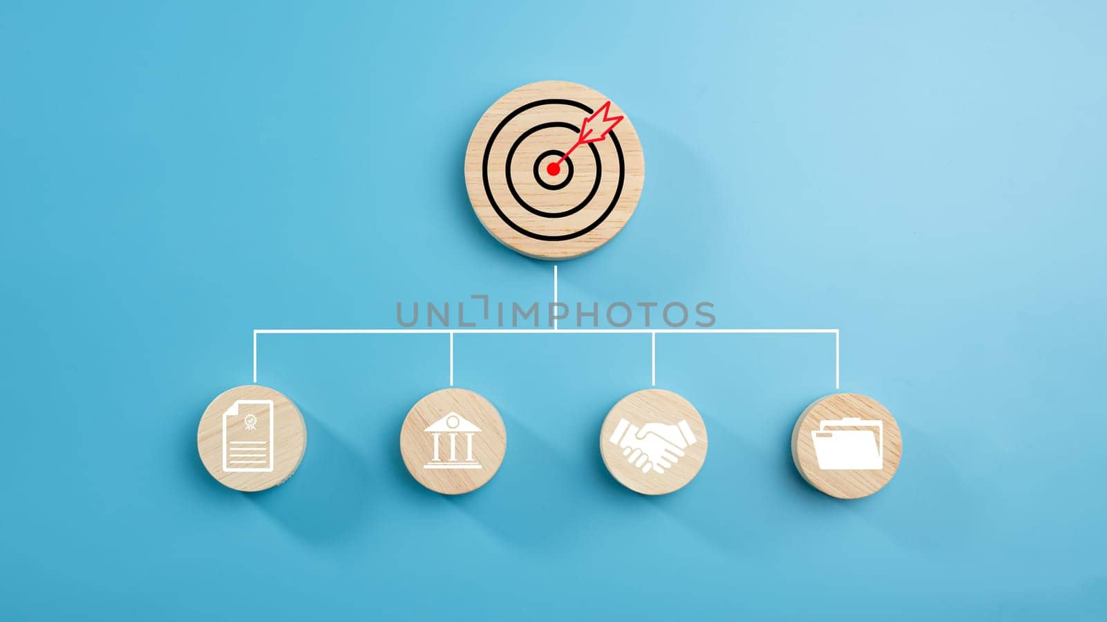 Circular wood with printed target icons and business symbols on light blue background, business goals and objectives concept, business competition, Customer relationship management concept.