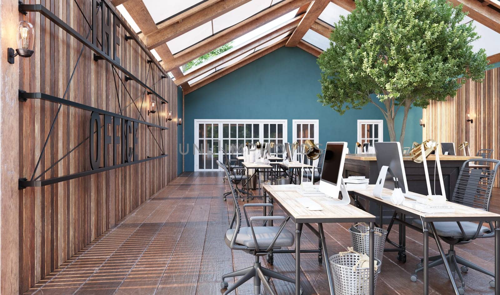 A large open office space with wooden floors . The space is filled with desks and chairs, and there are several potted plants scattered throughout the room