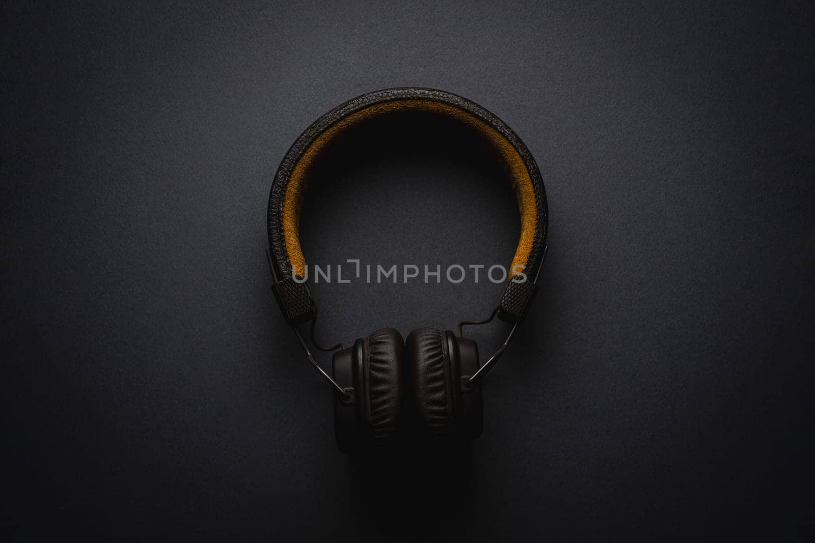 Retro style wireless over-ear headphones on dark gray background by Sonat