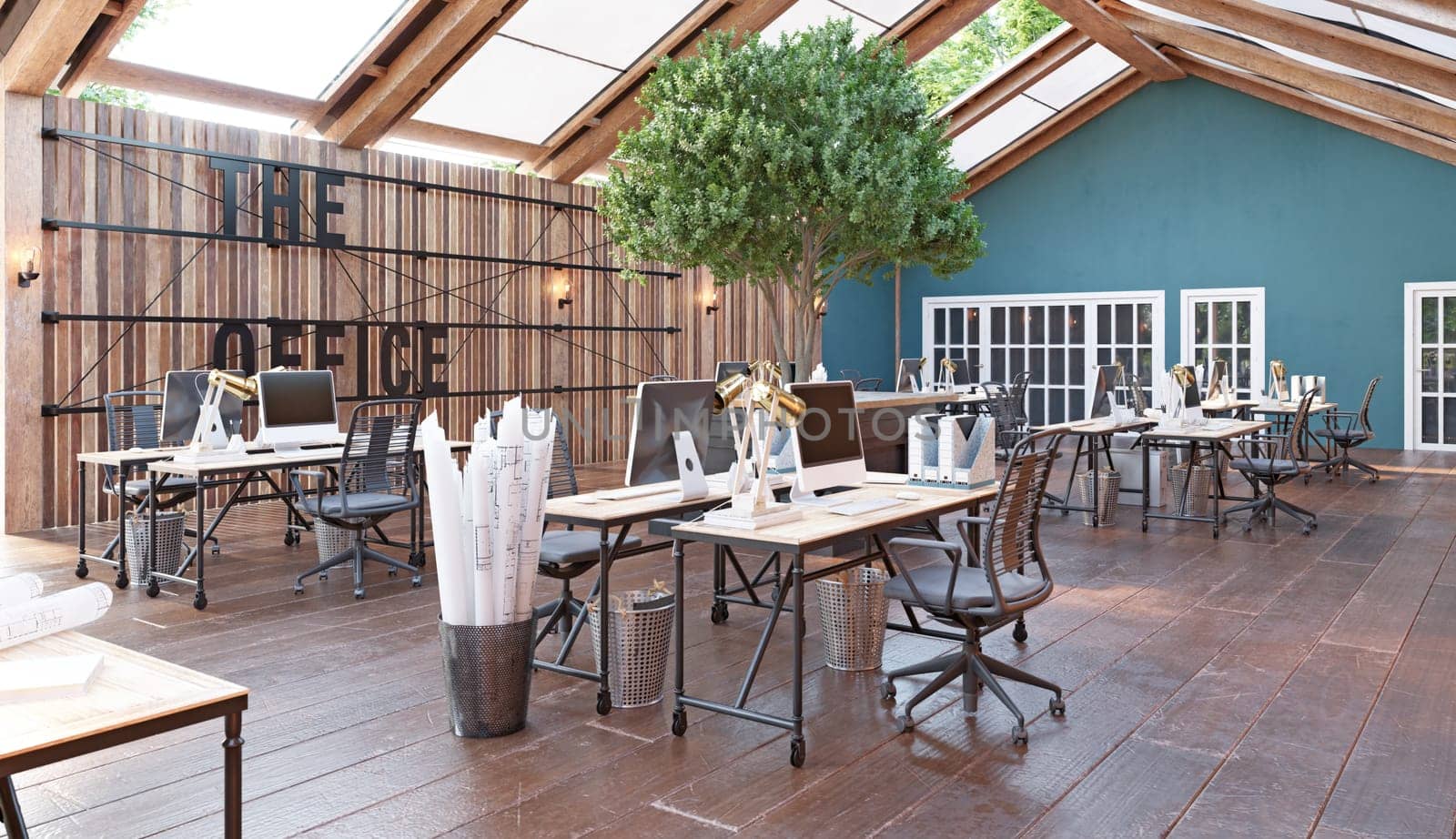 A large open office space with wooden floors . The space is filled with desks and chairs, and there are several potted plants scattered throughout the room