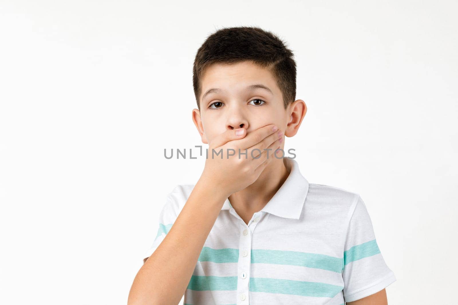 shocked surprised little child boy in t-shirt looking to camera on white background. Human emotions and facial expression