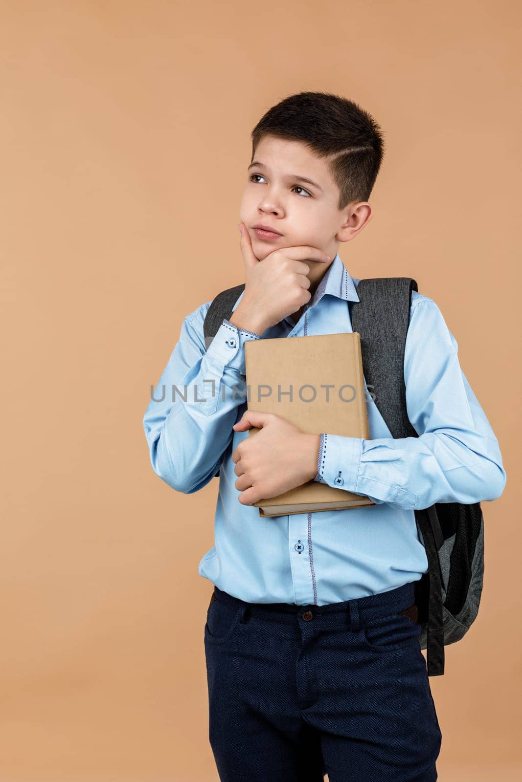 little cheerful school boy holding a book by erstudio