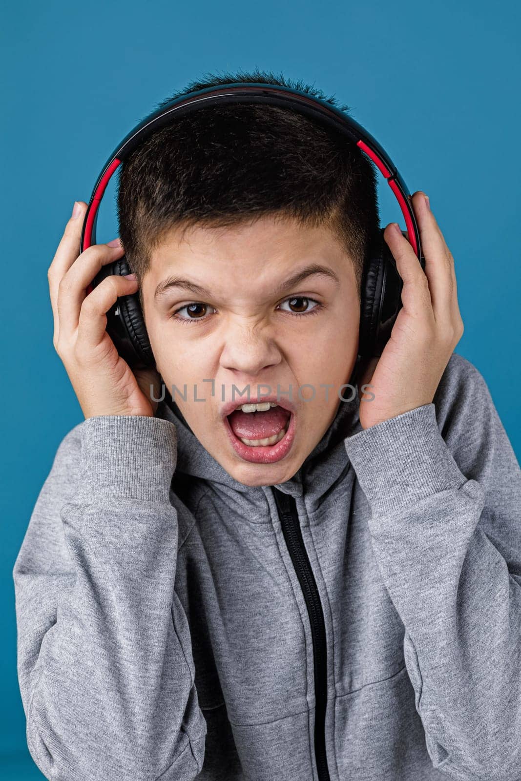 child boy enjoys listens to music in headphones by erstudio