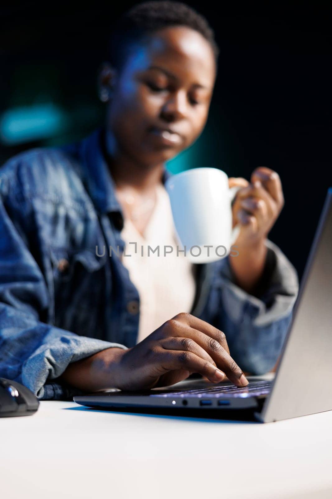 Woman drinks coffee and uses laptop by DCStudio