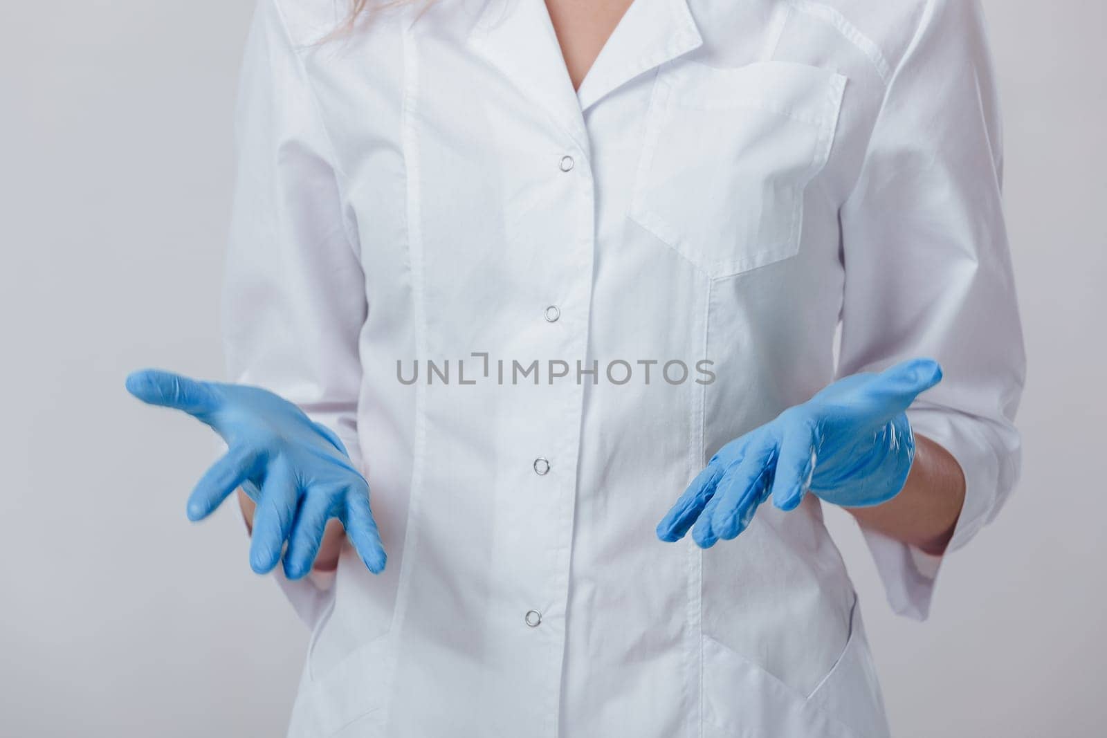 Woman doctor hands in medical latex blue gloves, close-up