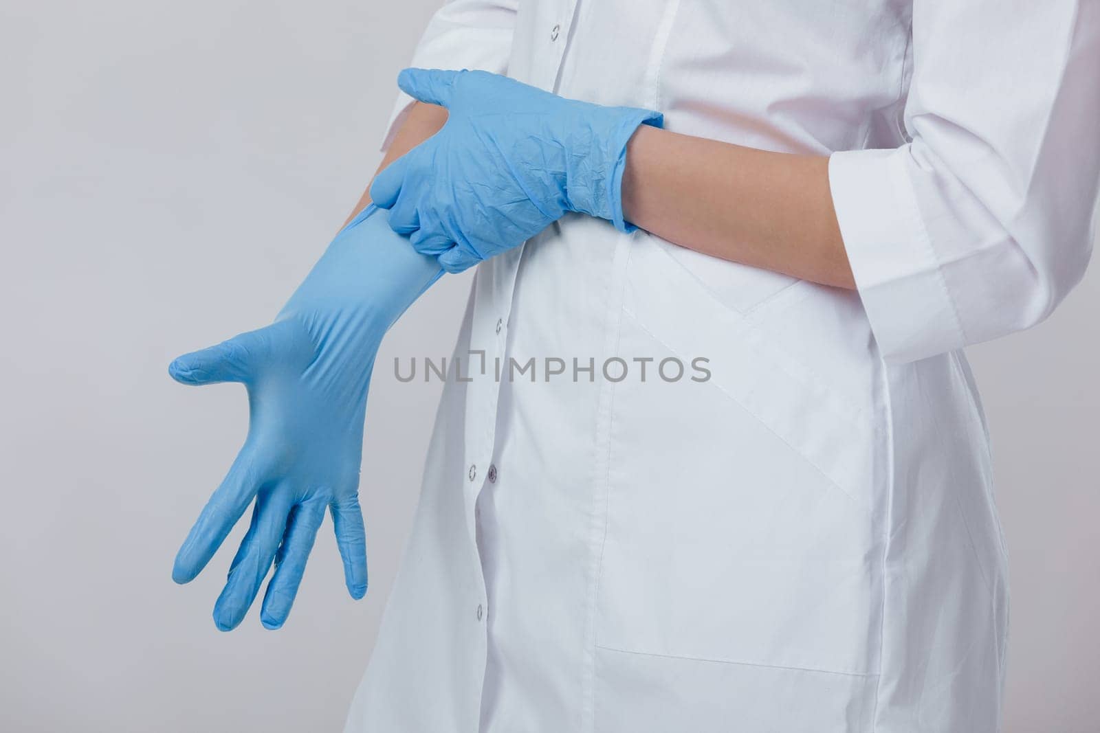 Woman doctor hands wears medical latex blue gloves, close-up