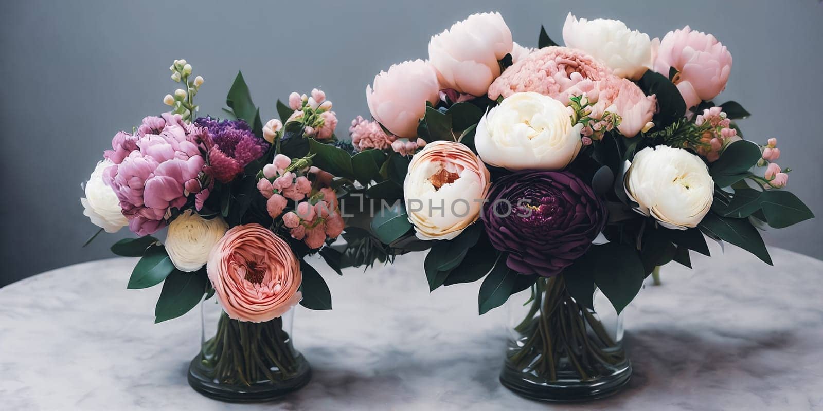 Sophisticated floral arrangement using a mix of different blooms such as peonies, hydrangeas, and ranunculus. Panorama