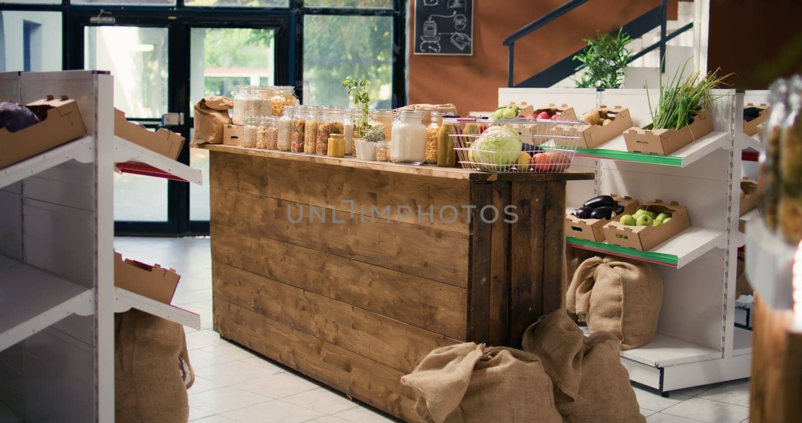 Bulk food items in reusable containers sold in zero waste supermarket to protect environmental changes. Eco friendly local shop with organic farming produce, pasta, spices and sauces.