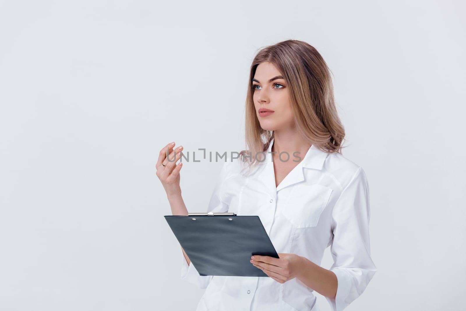 Medical physician doctor woman in white coat holding folder with documents and talking to someone