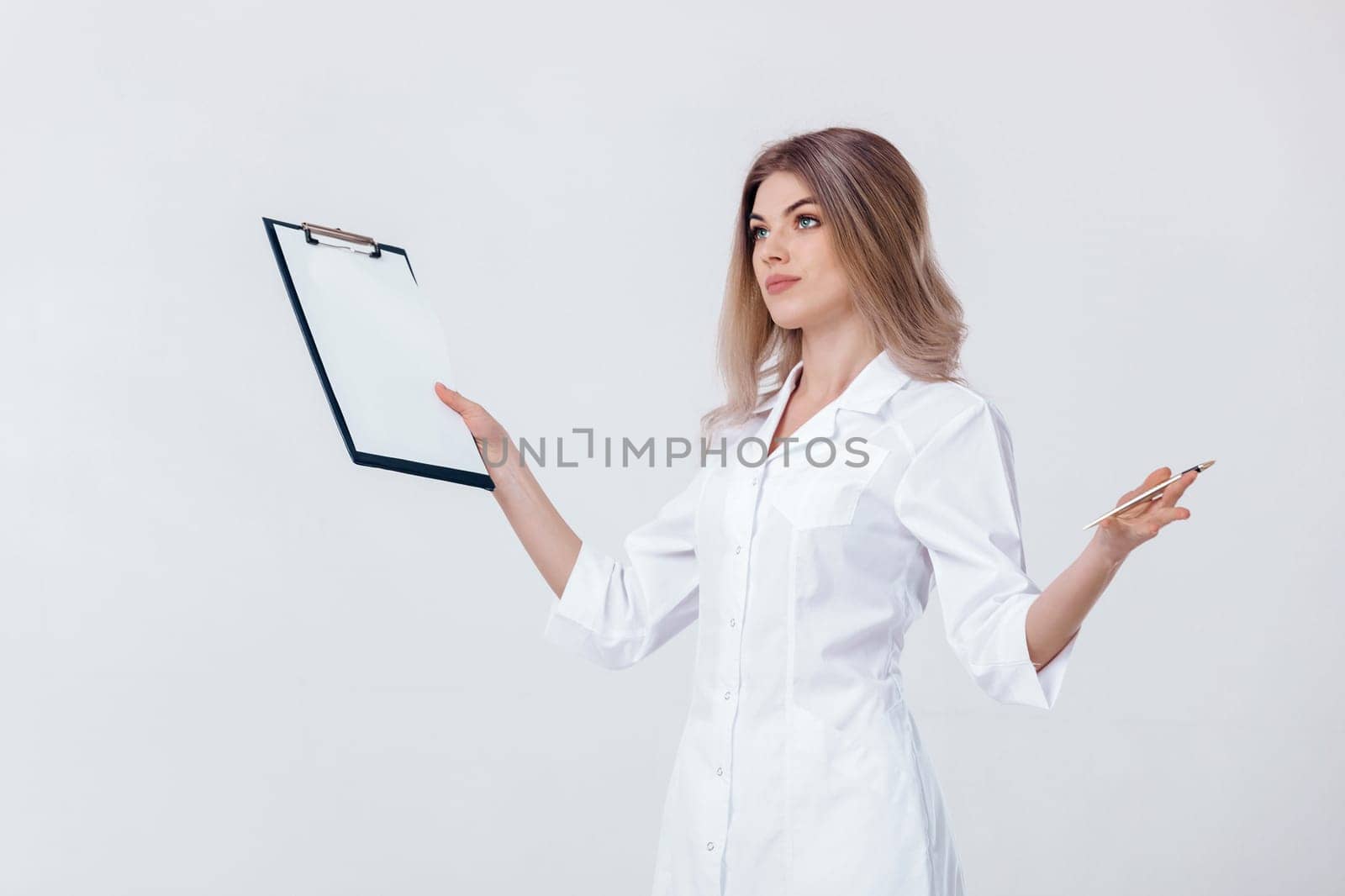 Medical physician doctor woman in white coat holds folder and spreads her arms to the side