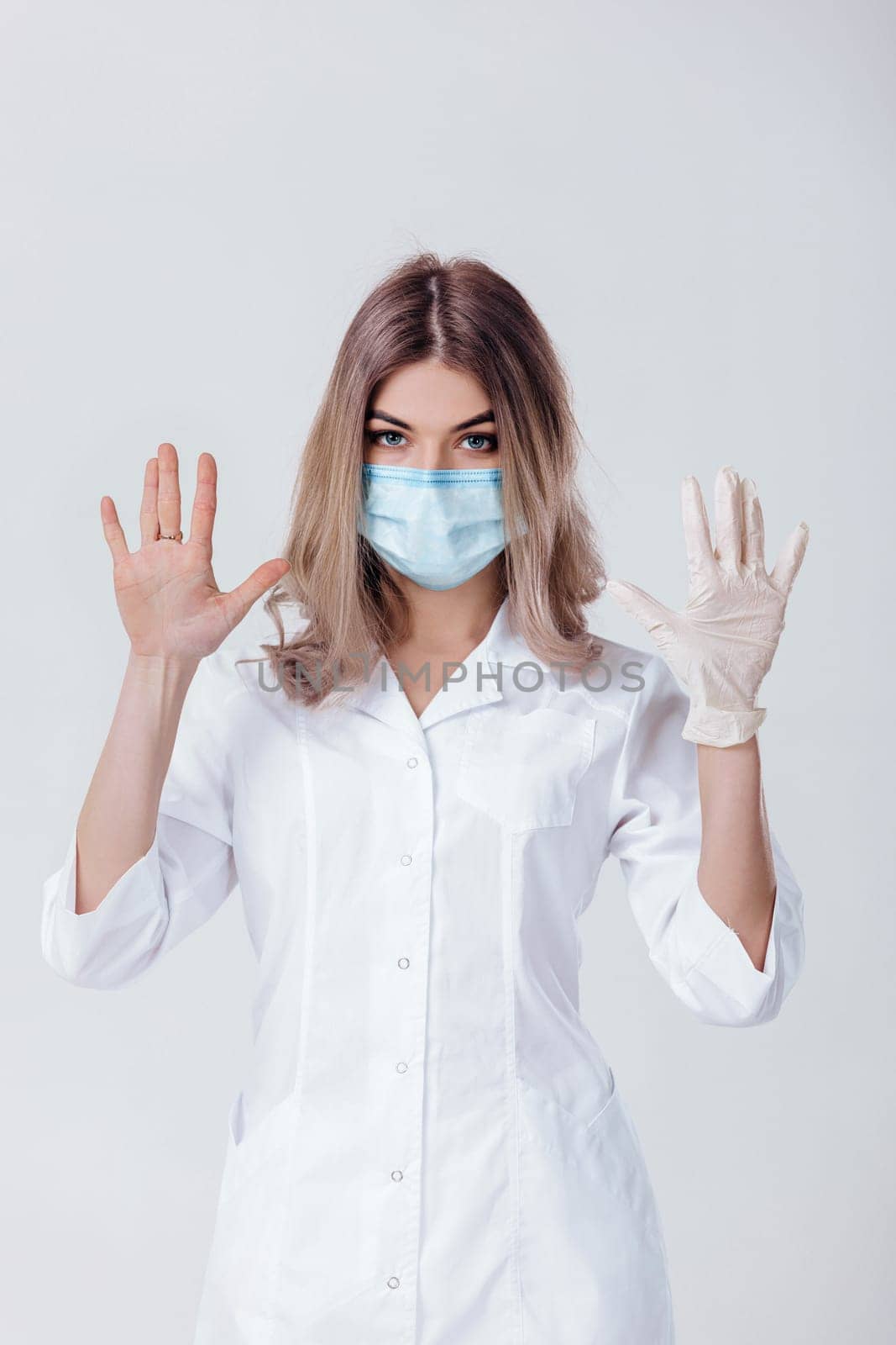 woman doctor with face mask and medical gloves by erstudio