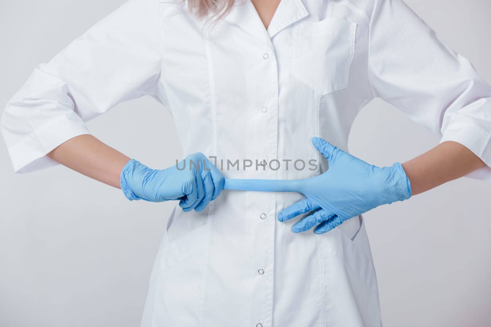 Woman doctor hands wears medical latex blue gloves, close-up