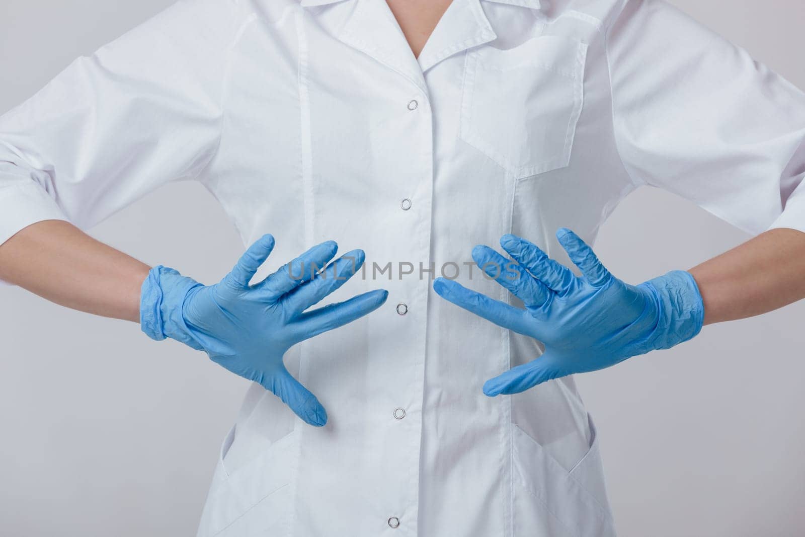 Woman doctor hands in medical latex blue gloves, close-up