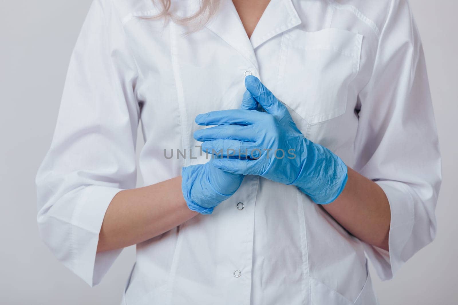 Woman doctor hands in medical latex blue gloves, close-up