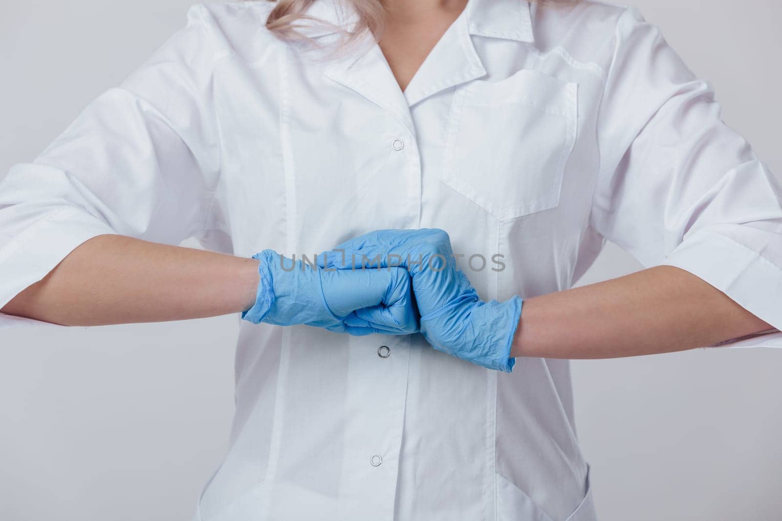 Woman doctor hands in medical latex blue gloves, close-up