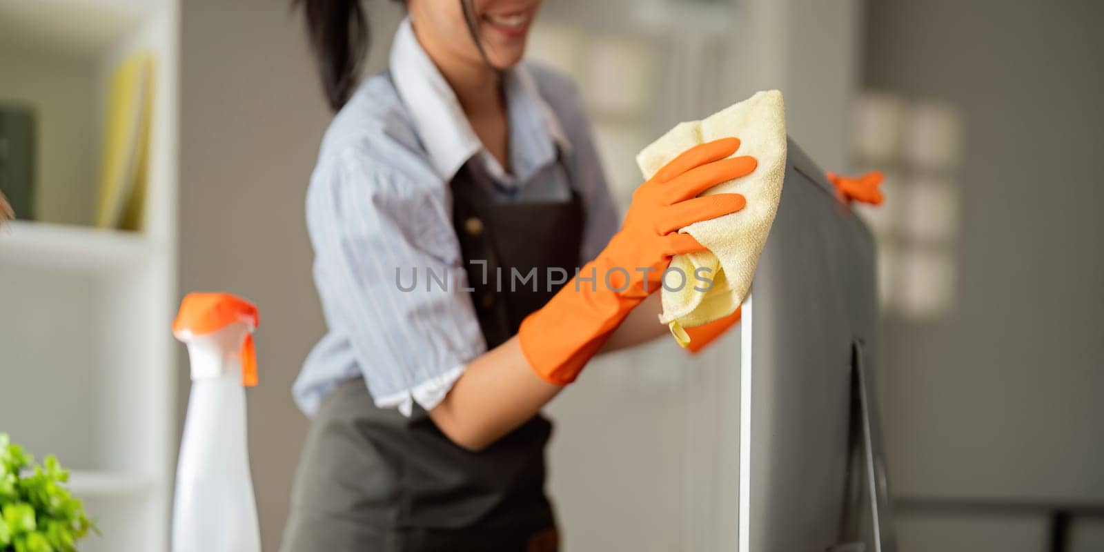 Woman clean in office room at office. Housekeeper or maid cleaner feel happy wipe mop and clean the work desk. the office office cleaning staff.